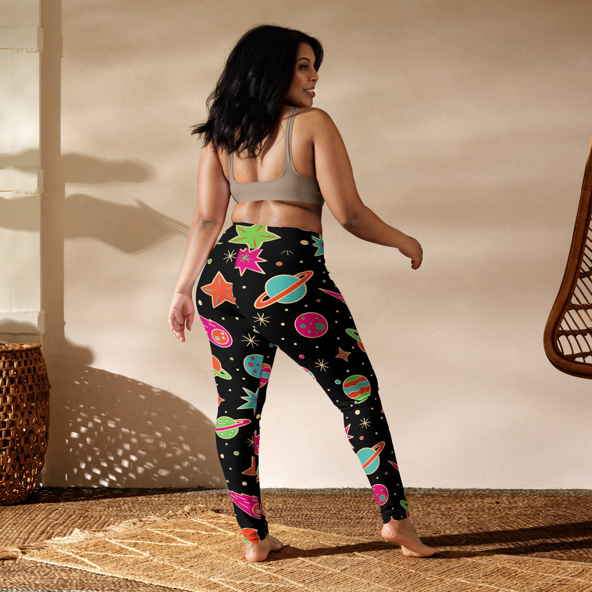 Women’s neon galaxy buttery soft yoga leggings in black with vibrant space-themed planets stars and saturn rings pattern