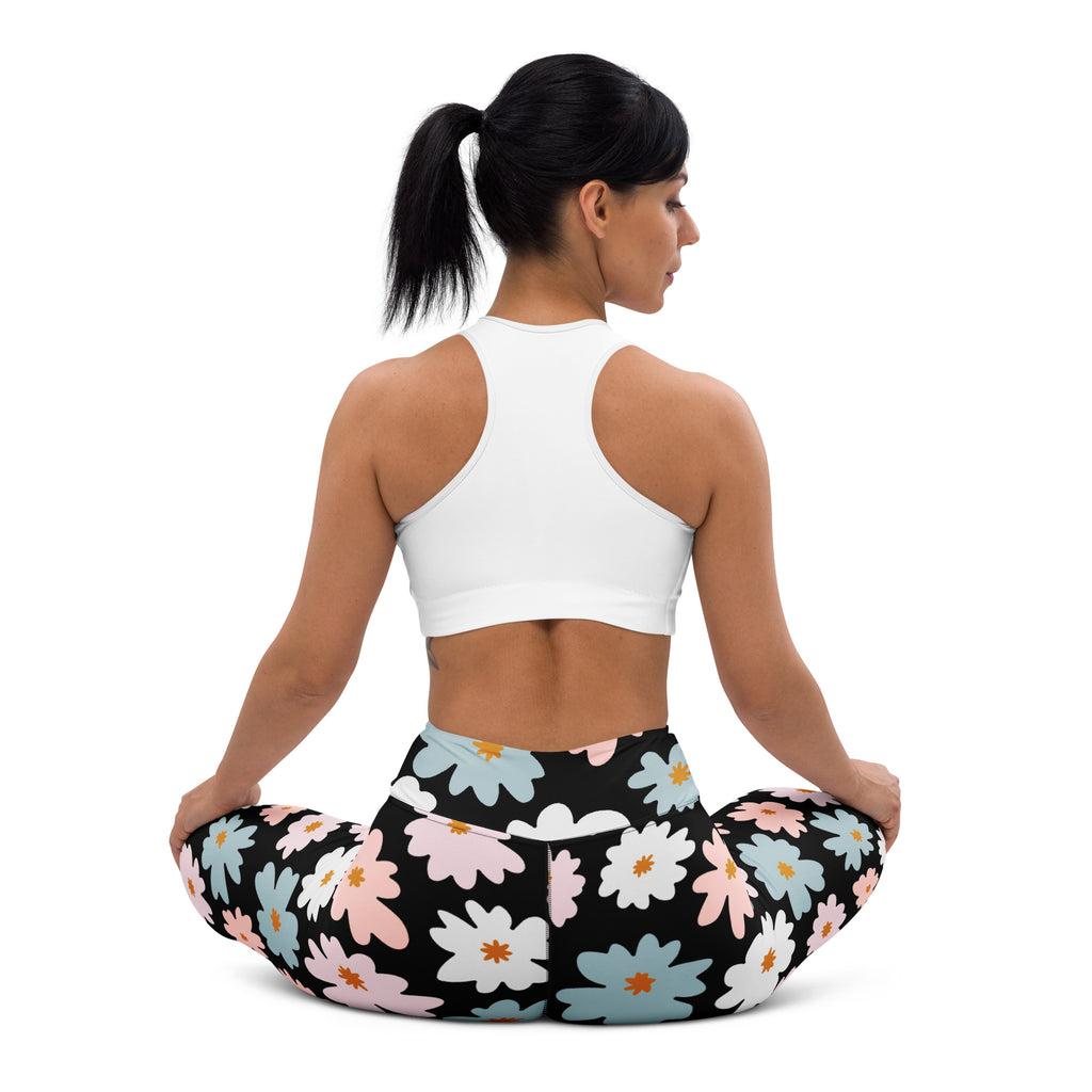 Women’s retro floral buttery soft yoga leggings in black with vibrant pink white and blue daisy pattern with orange centers
