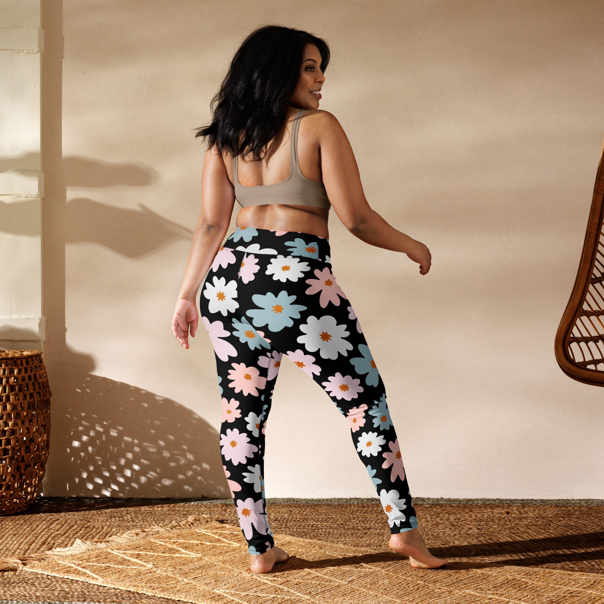 Women’s retro floral buttery soft yoga leggings in black with vibrant pink white and light blue daisy patterns