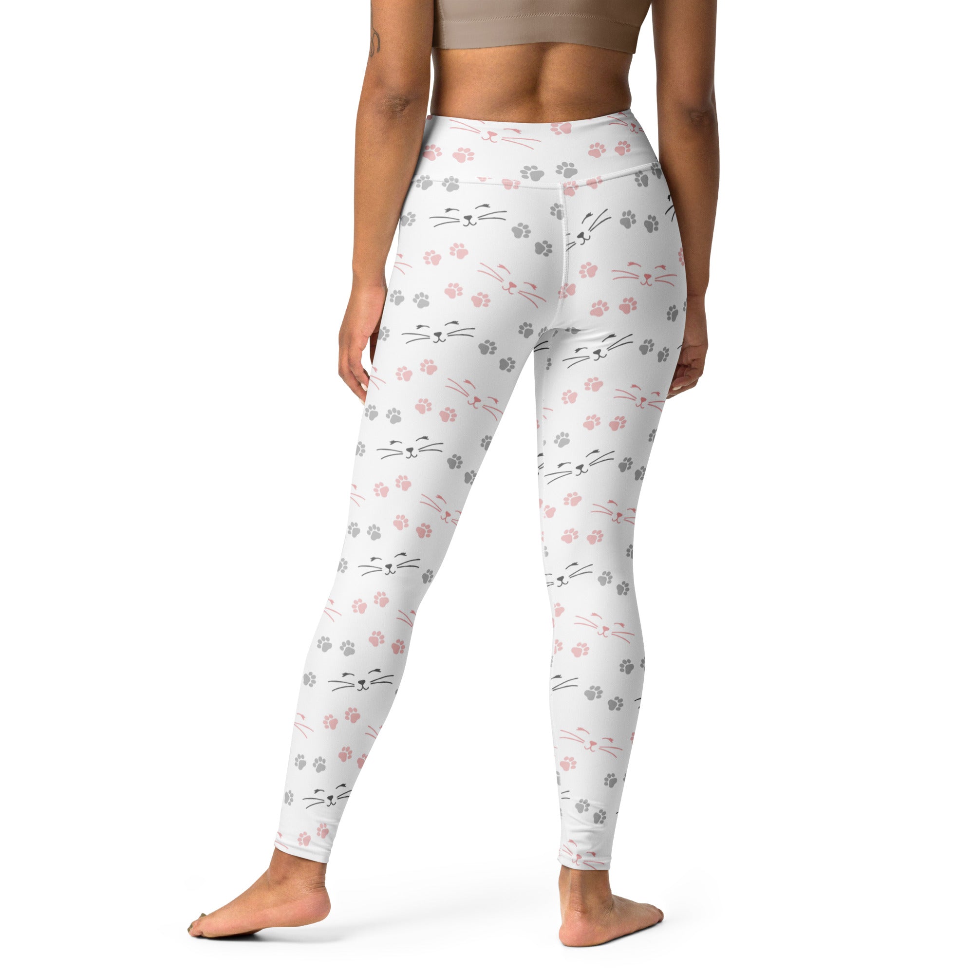 White leggings with pink and gray cat face and paw print pattern made of buttery soft fabric for women’s yoga use