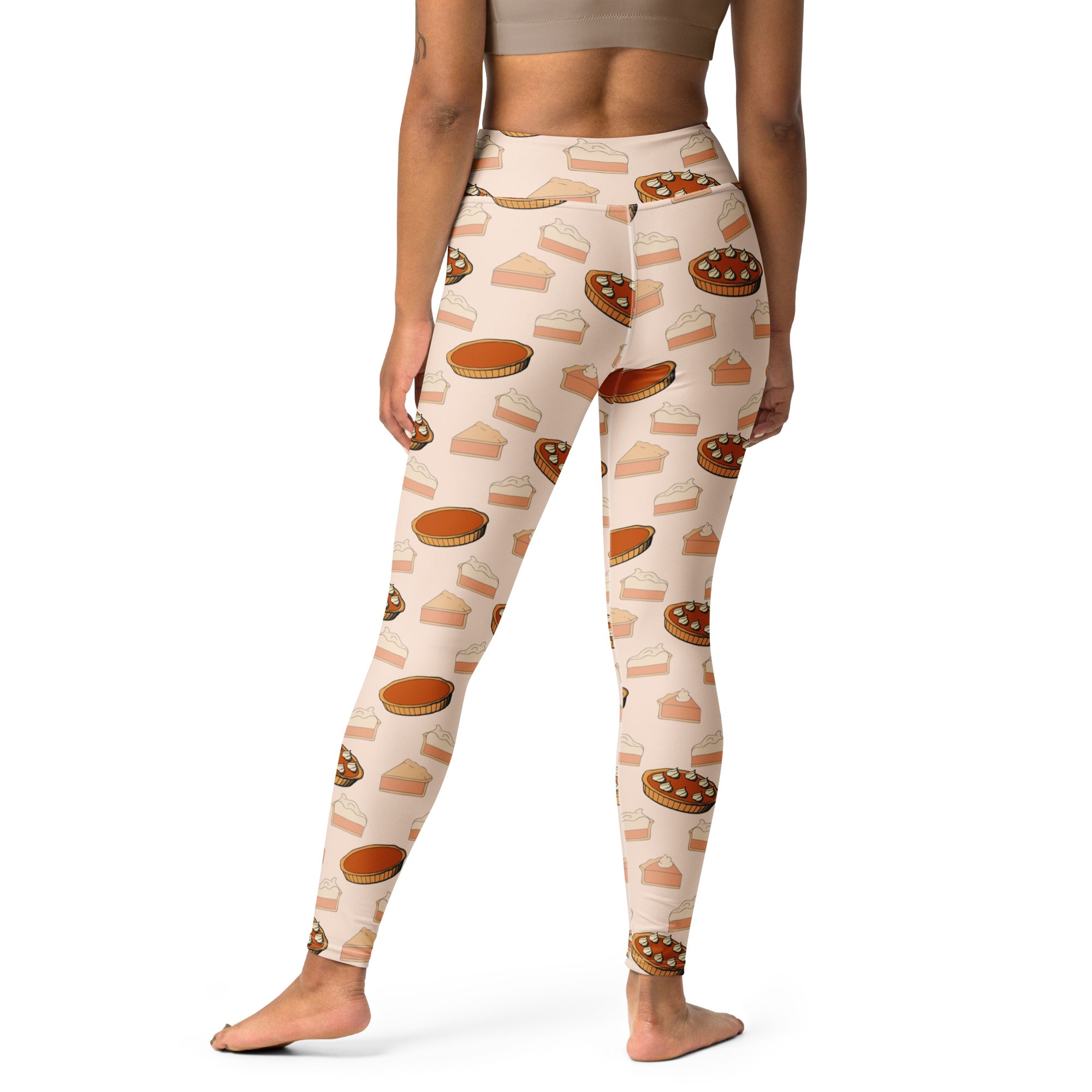 Cream-colored buttery soft women’s yoga leggings featuring a playful pattern of illustrated pumpkin pies for thanksgiving
