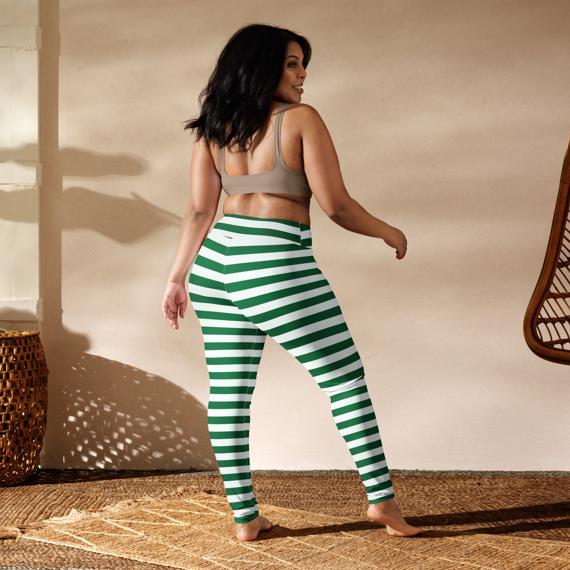 Women’s green and white striped high-waisted buttery soft yoga leggings shown from the back side