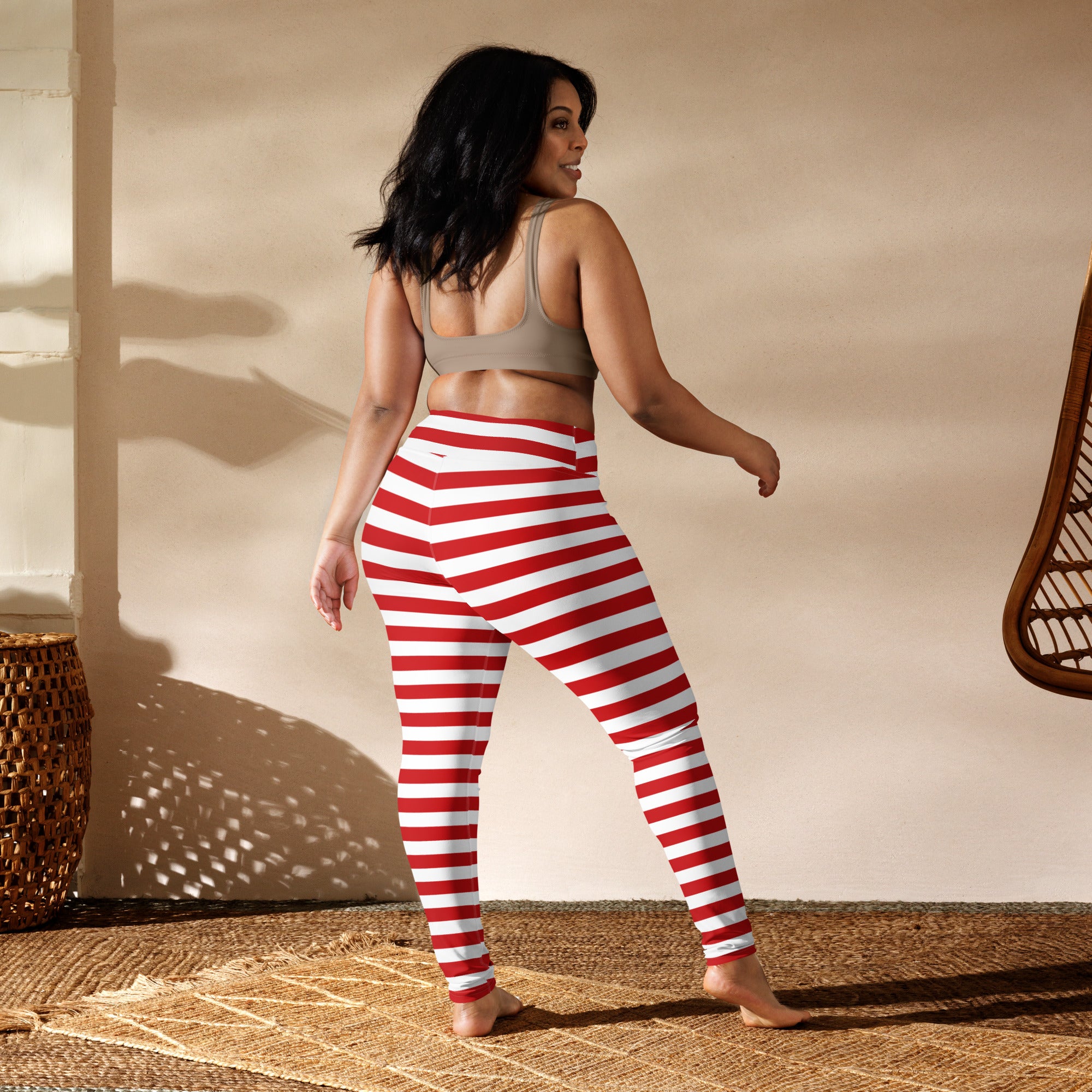 Women’s red and white striped buttery soft high-waisted yoga leggings shown from the back side