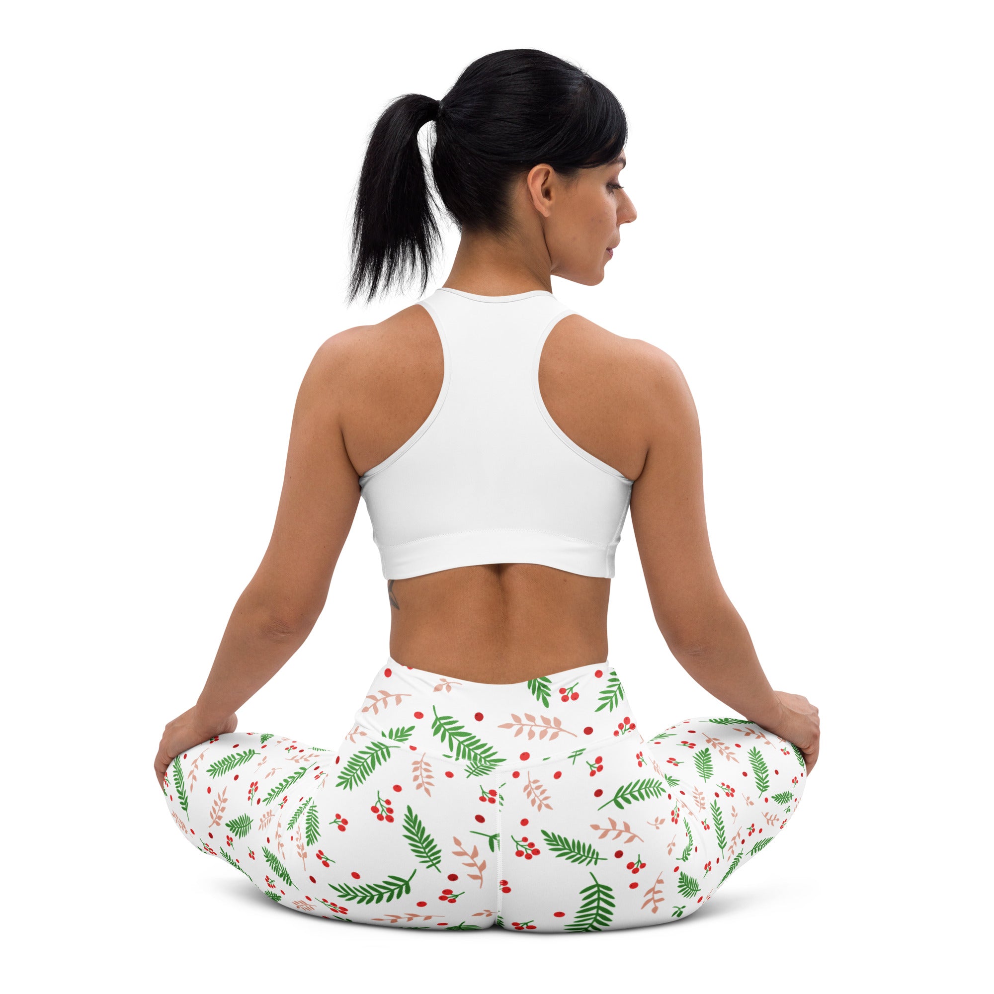 White women’s winter berry buttery soft yoga leggings with green fern and red berry festive pattern on white background