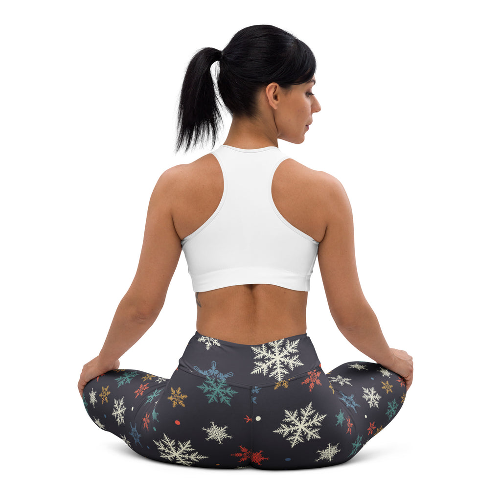 Black women’s winter snowflake buttery soft yoga leggings with multicolored snowflake pattern in white teal gold and red
