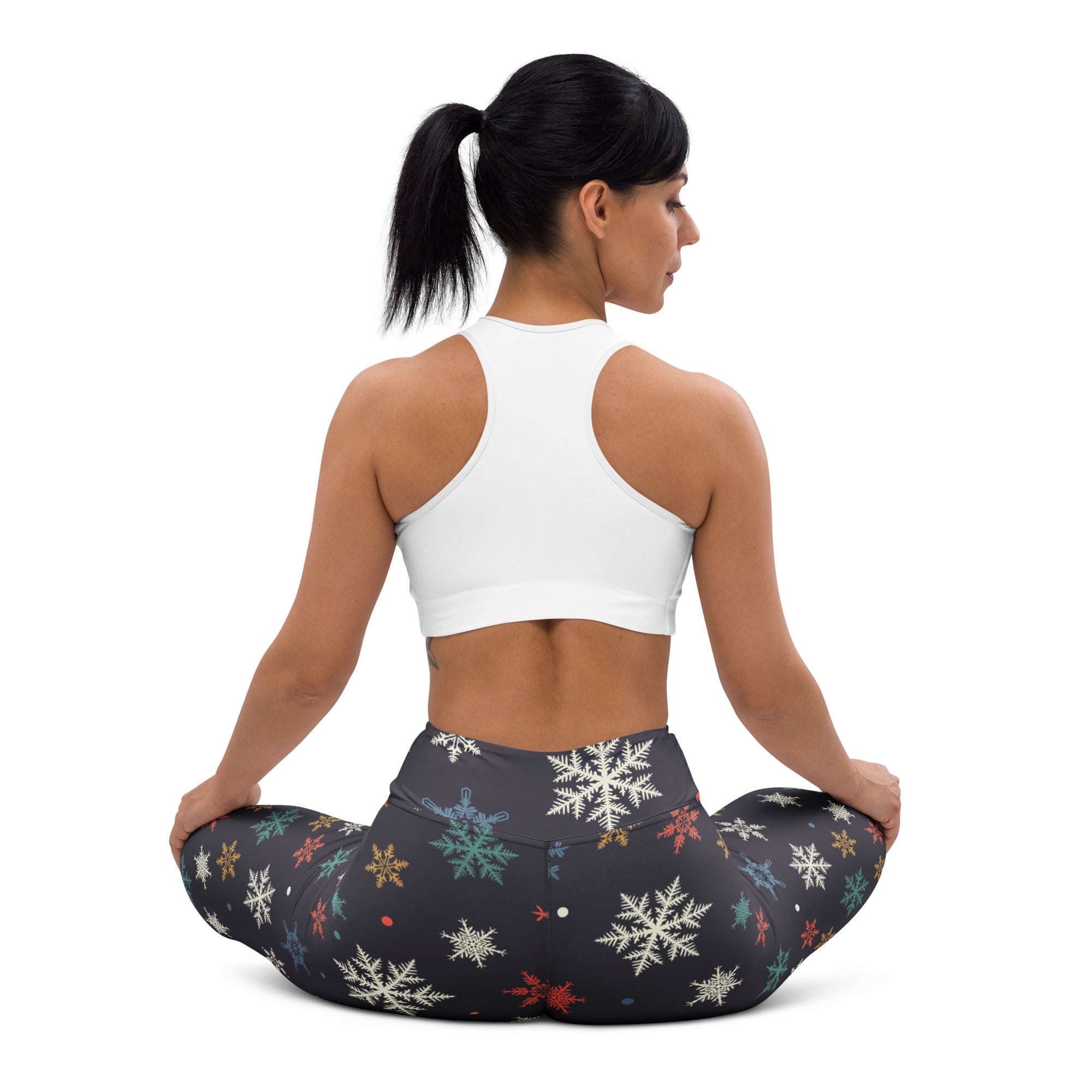 Black women’s winter snowflake buttery soft yoga leggings with multicolored snowflake pattern in white teal gold and red