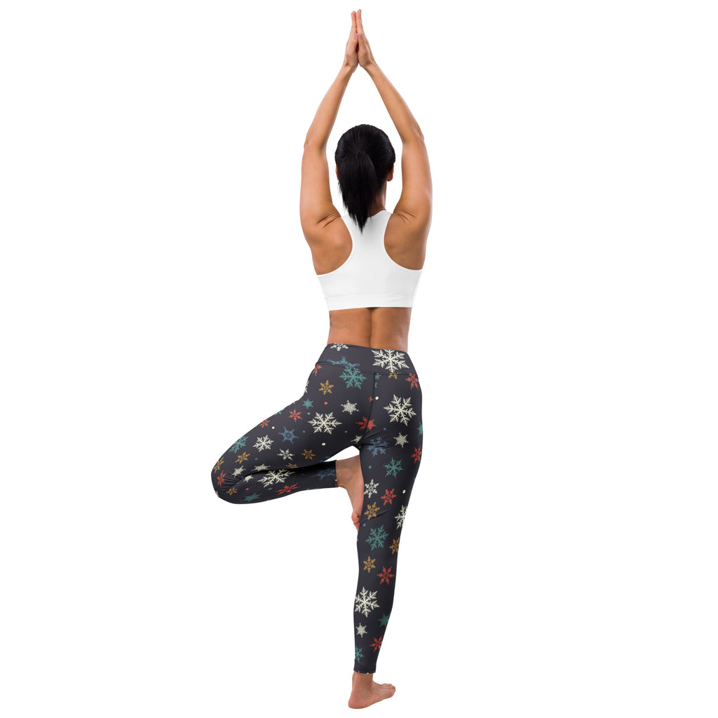 Black buttery soft women’s yoga leggings with multicolored snowflake pattern in white blue green and red