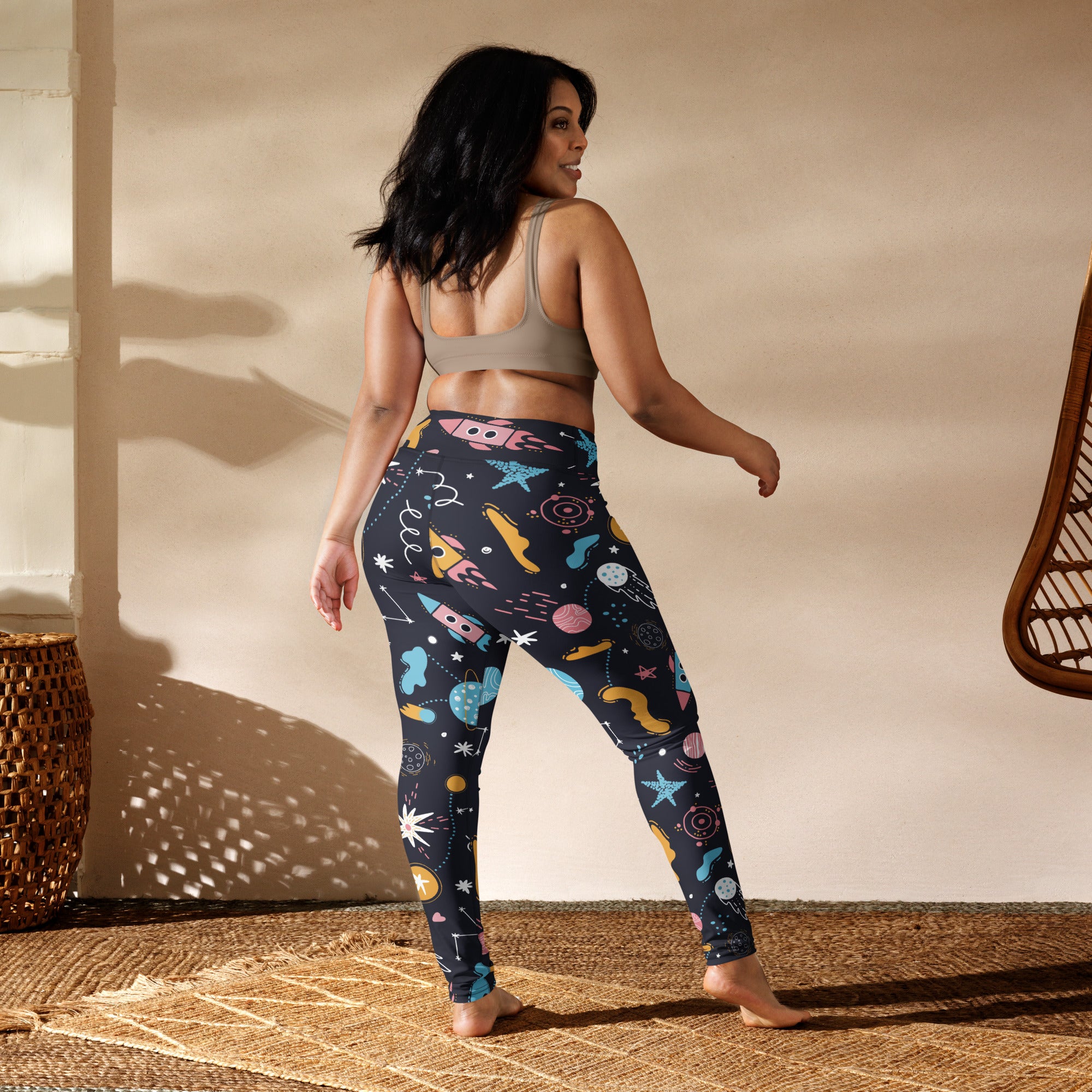 Women’s outer space buttery soft yoga leggings in dark navy with vibrant pastel rockets stars planets and cosmic shapes