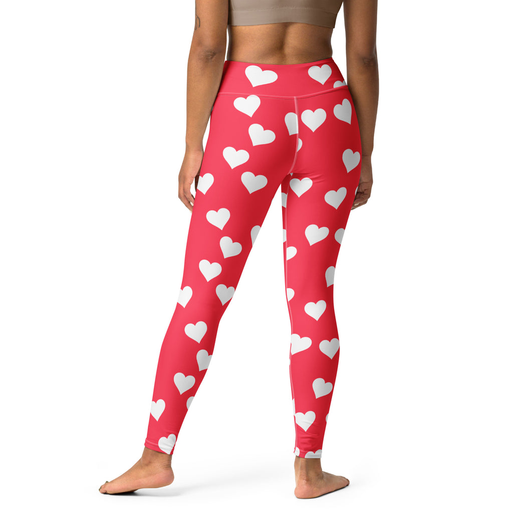 Women’s bright pink high waisted yoga leggings with red heart print made of buttery soft quick drying fabric