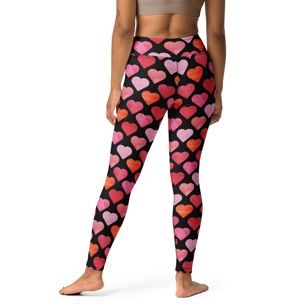 Women’s high waisted buttery soft black yoga leggings with vibrant pink red and orange watercolor heart pattern