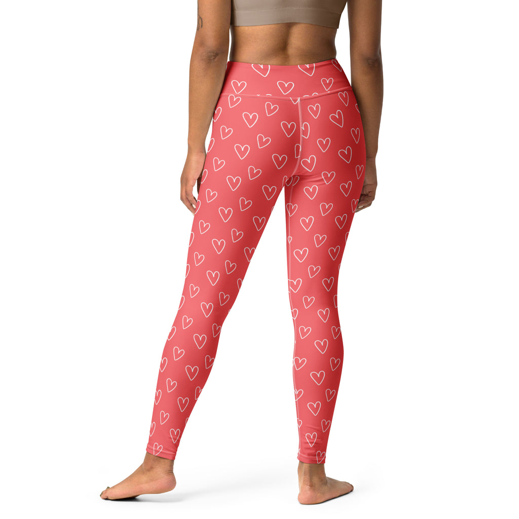 Coral pink high-waisted buttery soft yoga leggings with white outlined hearts and quick drying fabric for comfort