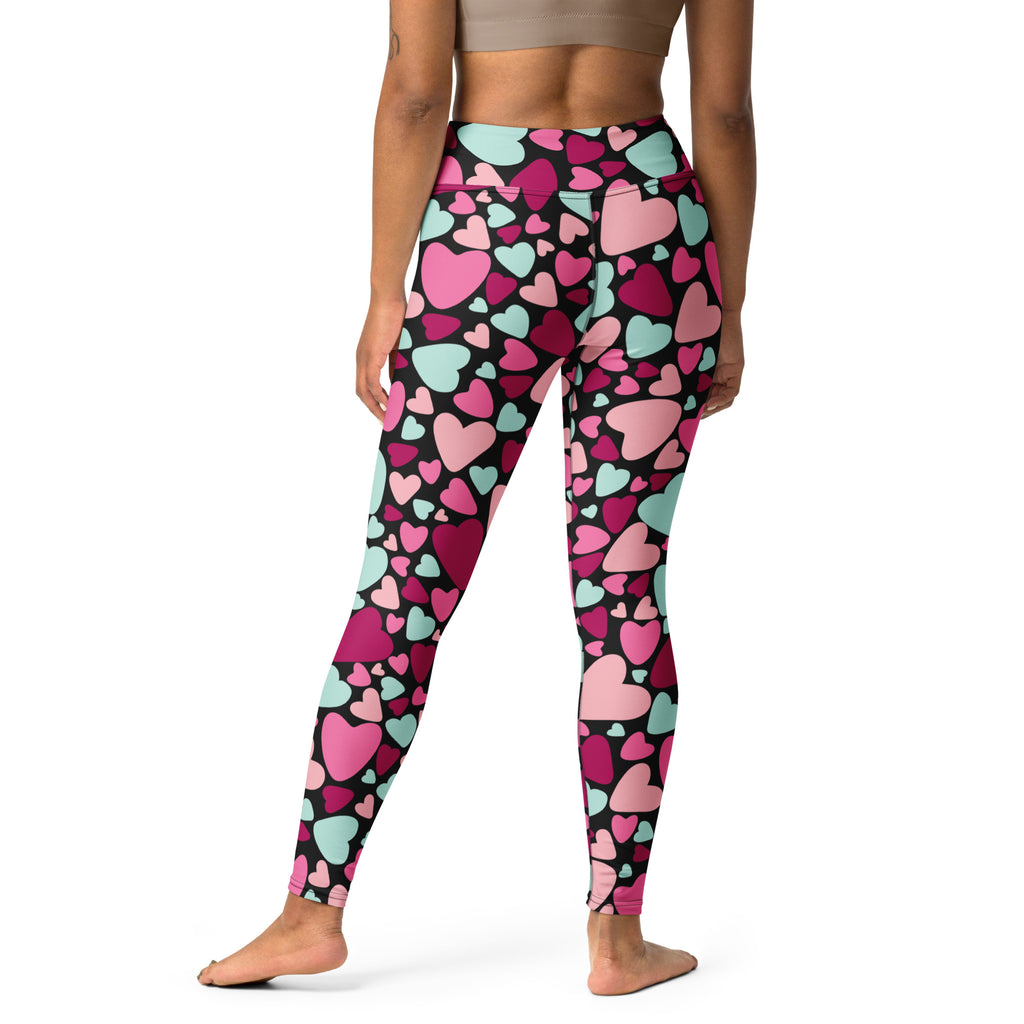 High-waisted women’s leggings with vibrant pink and mint green hearts on black, buttery soft and quick drying for yoga