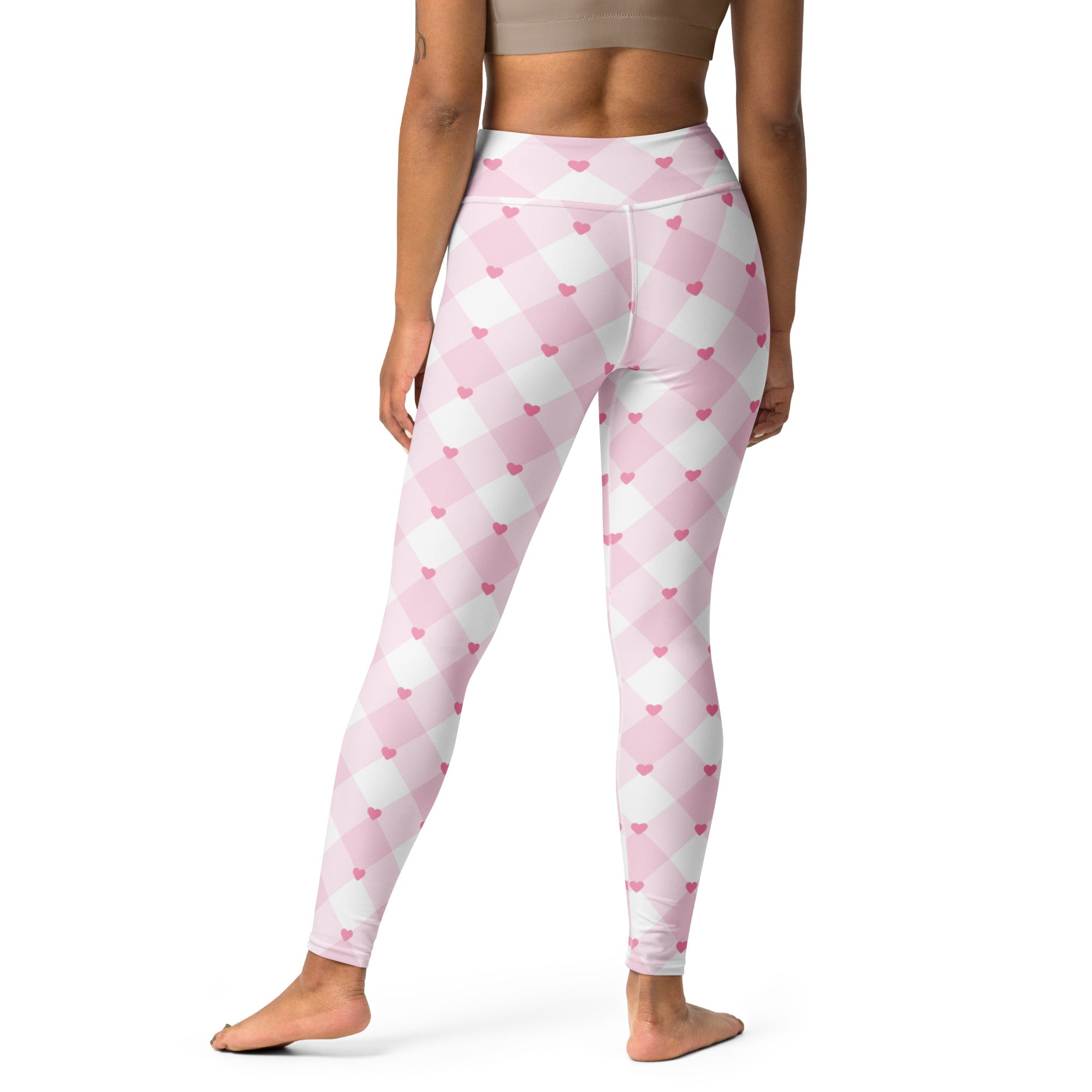Women’s pink and white argyle patterned high waisted buttery soft yoga leggings with small pink heart accents and quick drying fabric