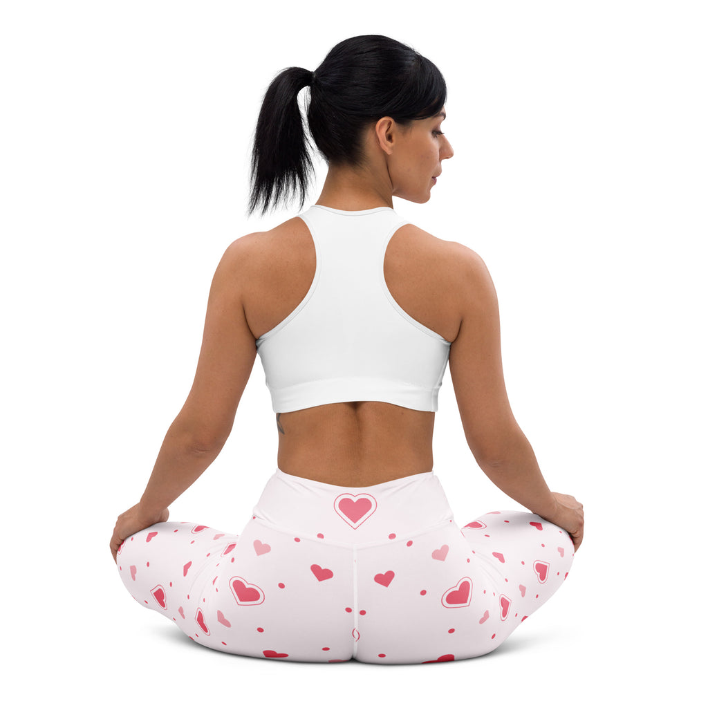 White women’s high waisted yoga leggings with a soft pink heart and dot pattern quick drying buttery soft fabric