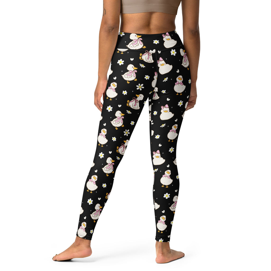 Women’s black buttery soft high waisted yoga leggings with white ducks wearing pink bows and small flowers pattern