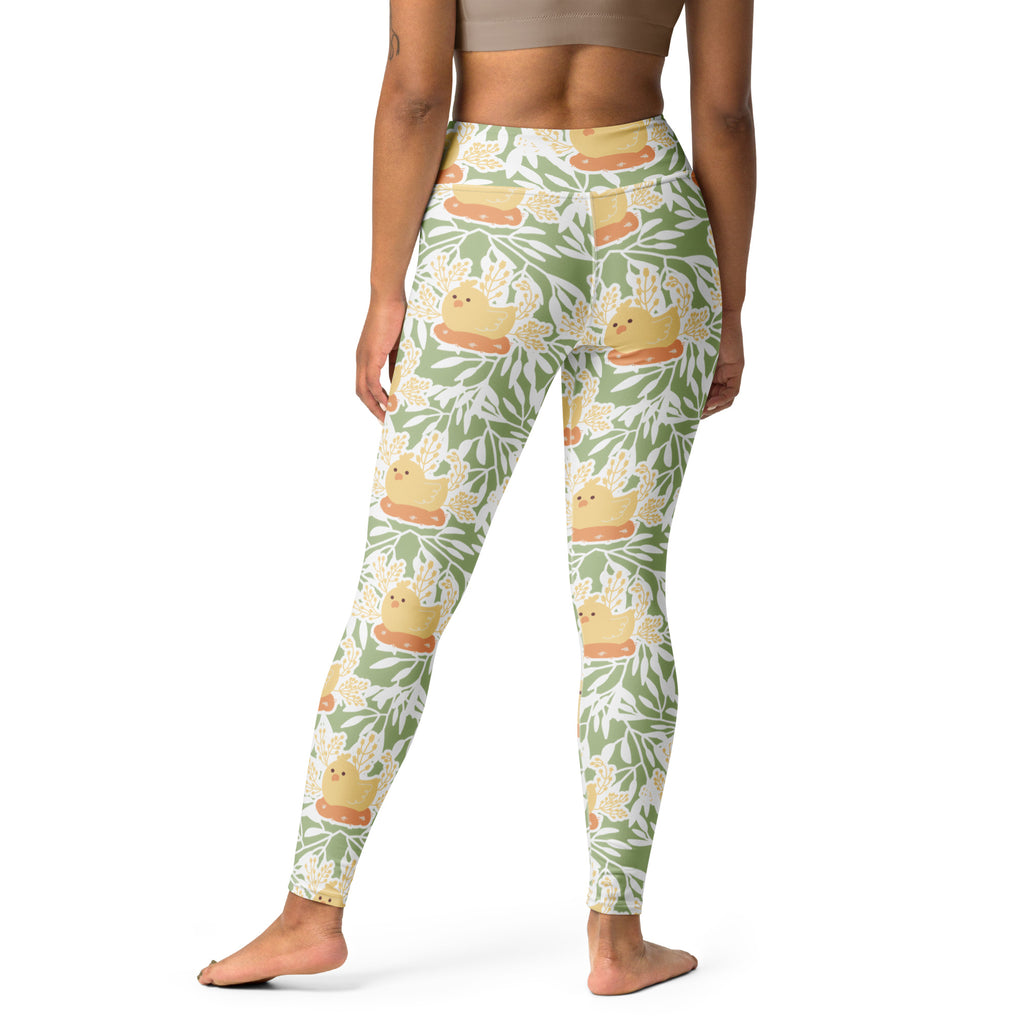 Women’s spring chick buttery soft green and white leggings with yellow rubber duckies on orange rafts and leafy pattern
