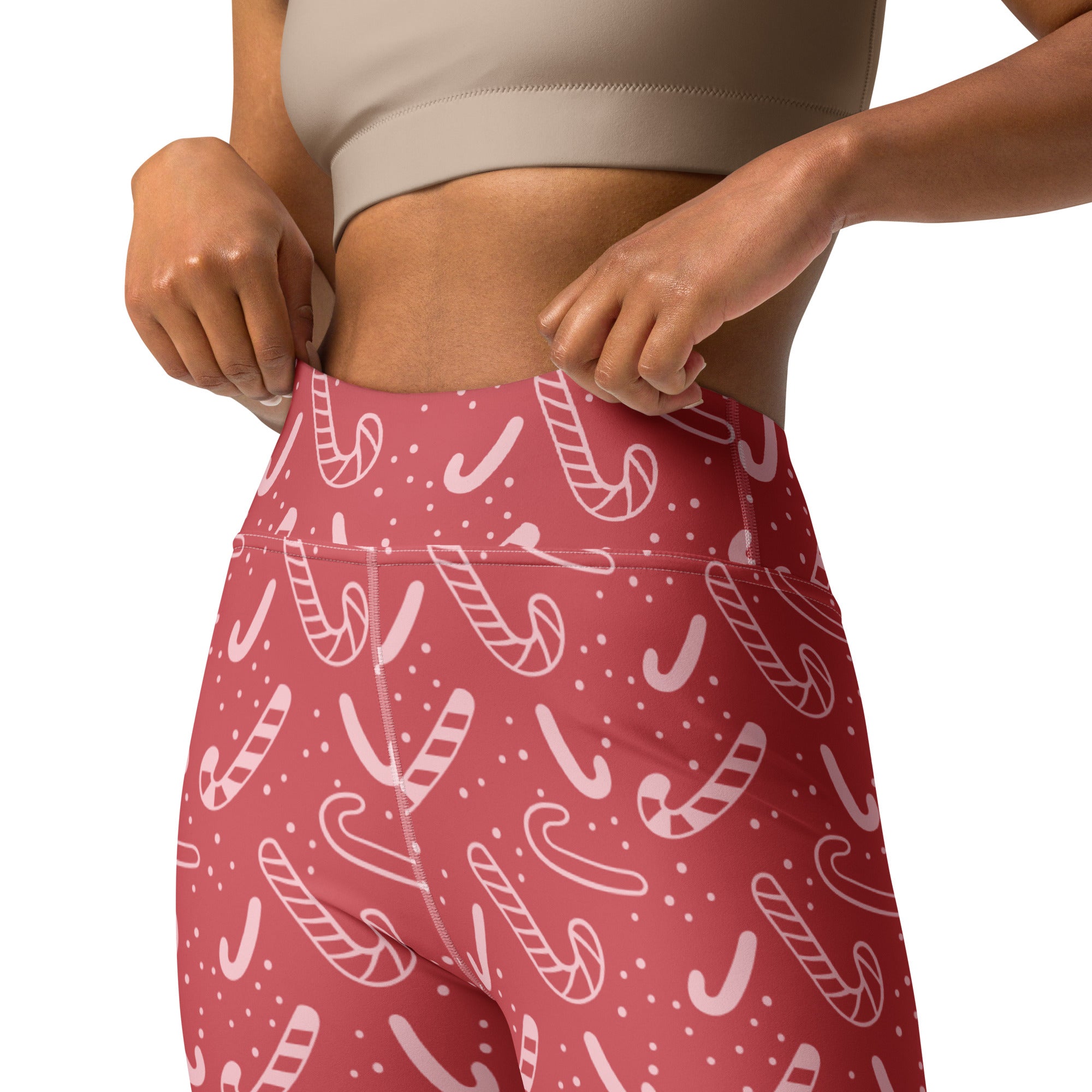 Women’s red high-waisted buttery soft yoga leggings with a festive white candy cane and small dot pattern