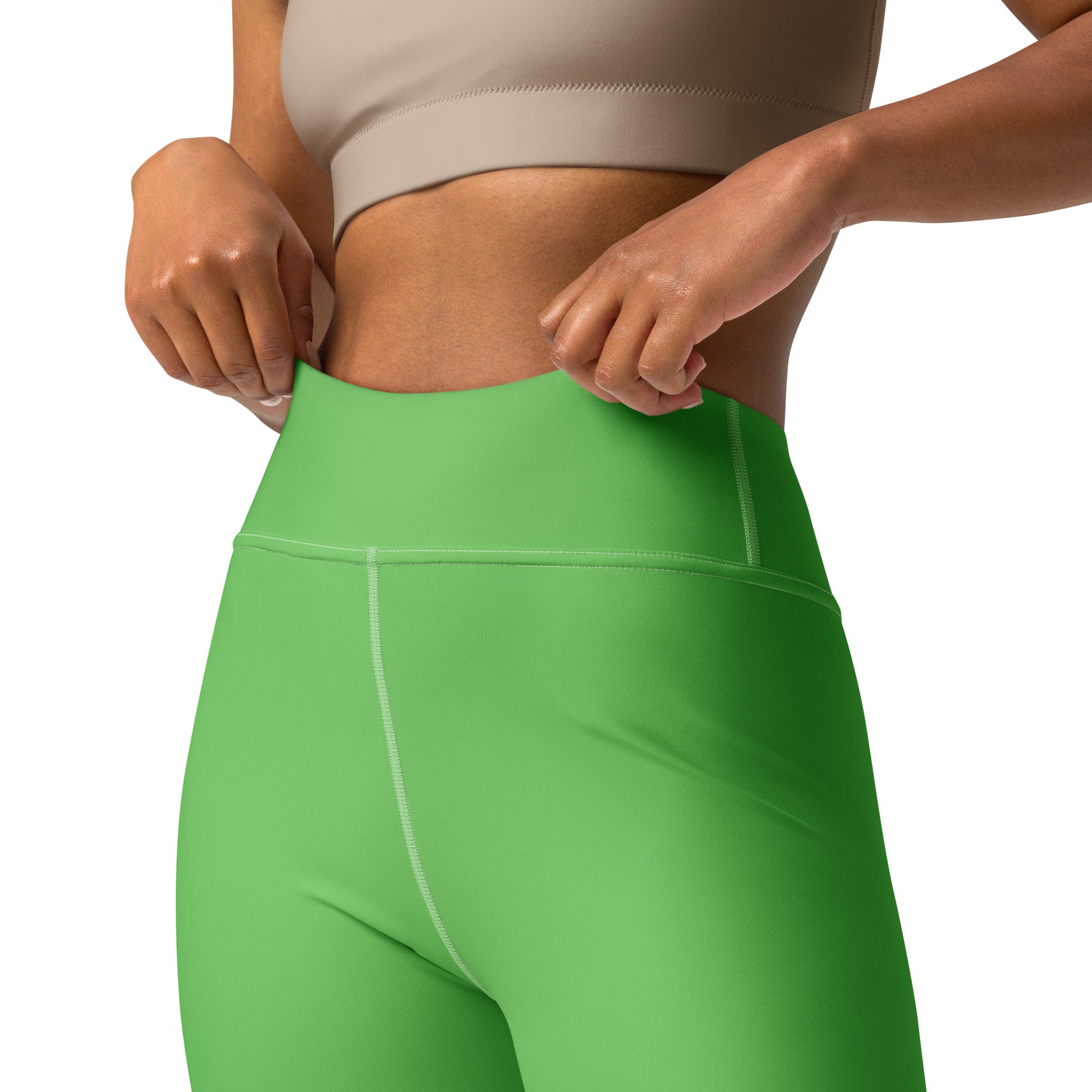 Bright green high-waisted women’s yoga leggings in seamless stretchy fabric with subtle white stitching on the waistband
