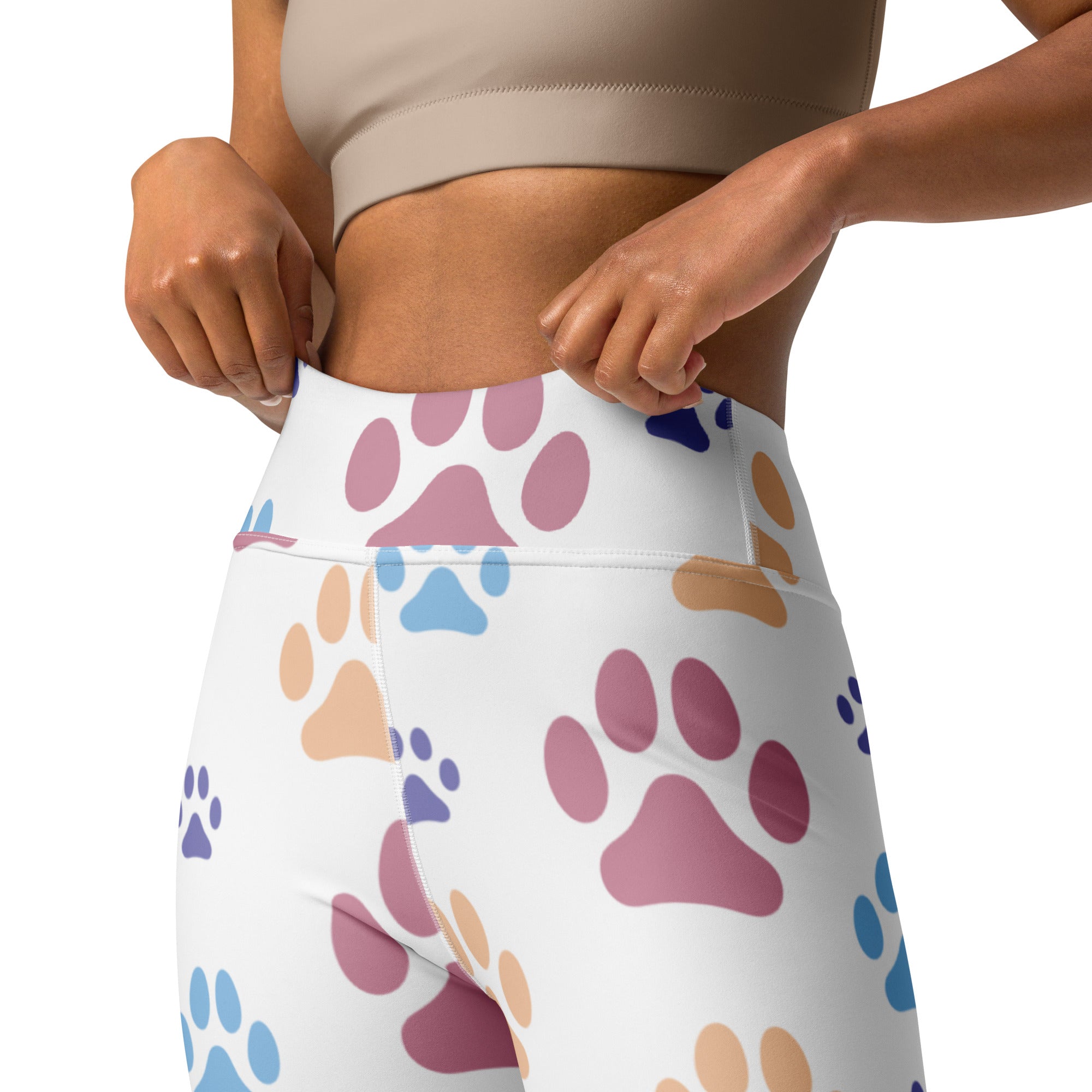 White high-waisted buttery soft yoga leggings with a playful multicolored paw print pattern for women