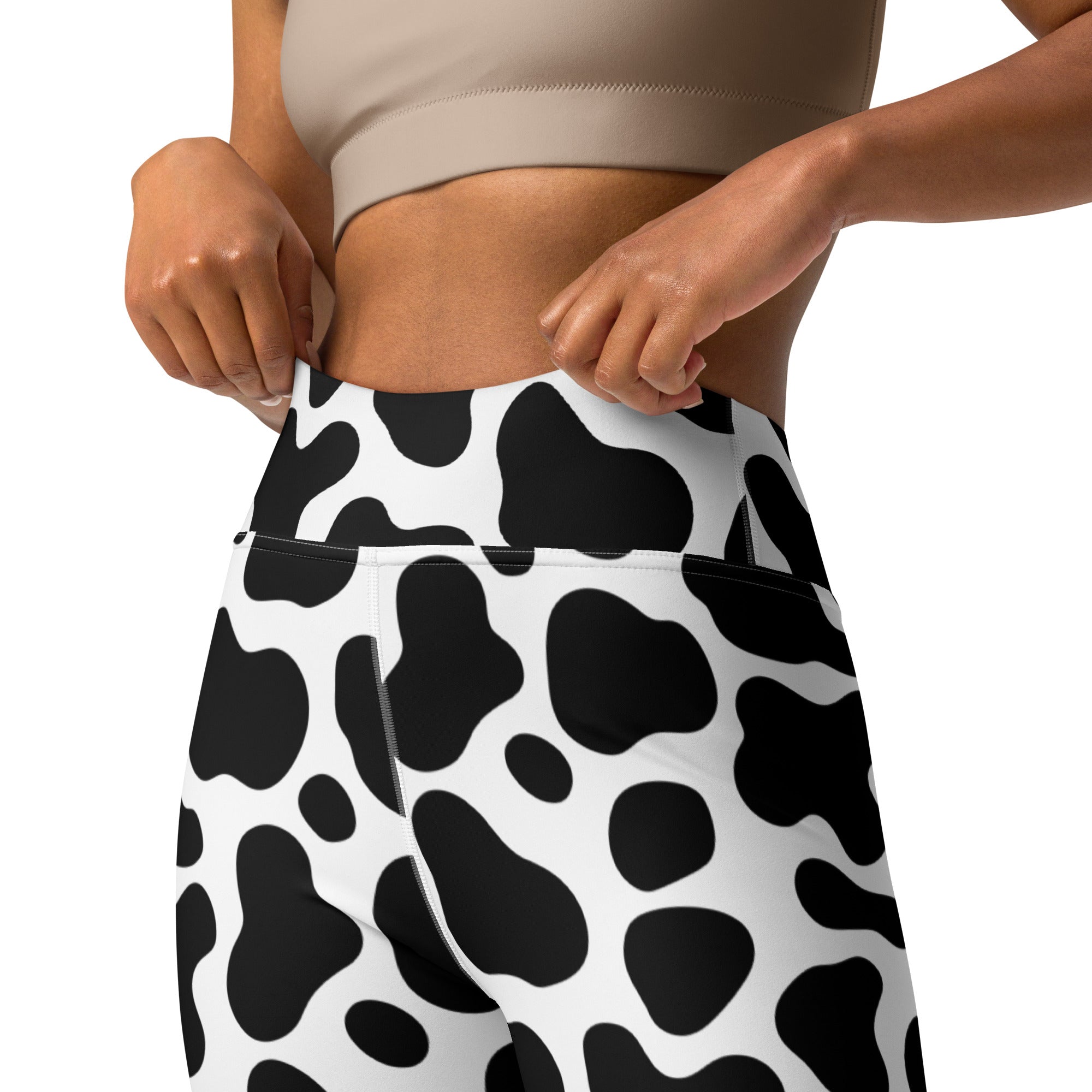 High-waisted women’s cow print buttery soft black and white yoga leggings with bold pattern and comfortable fit