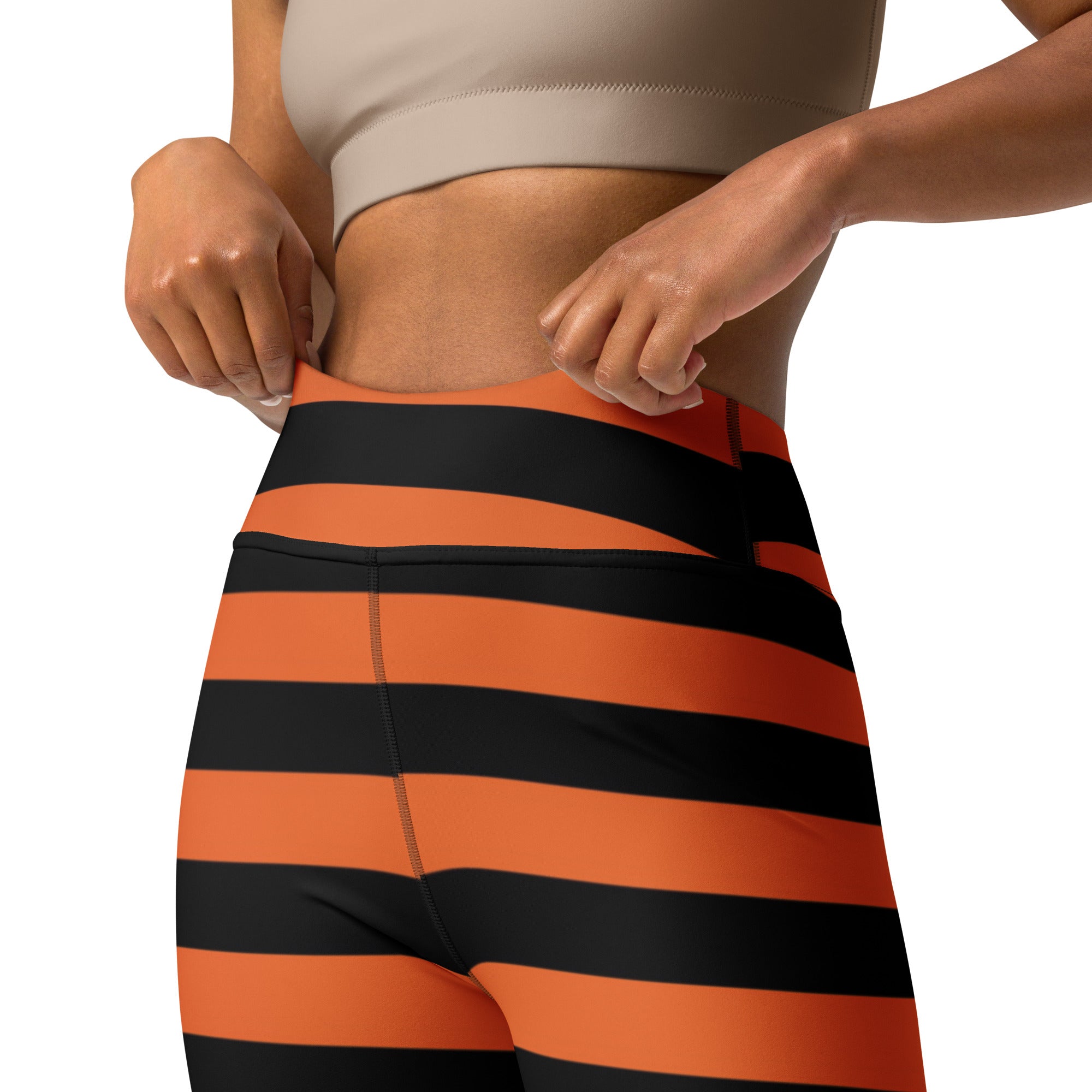 High-waisted women’s orange and black striped buttery soft yoga leggings perfect for Halloween workouts