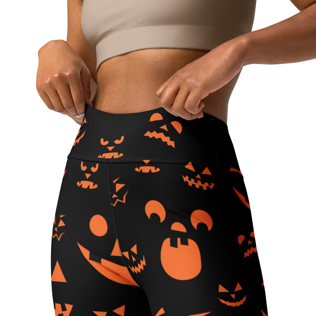 Women’s black high-waisted buttery soft yoga leggings with vibrant orange jack-o-lantern faces for halloween