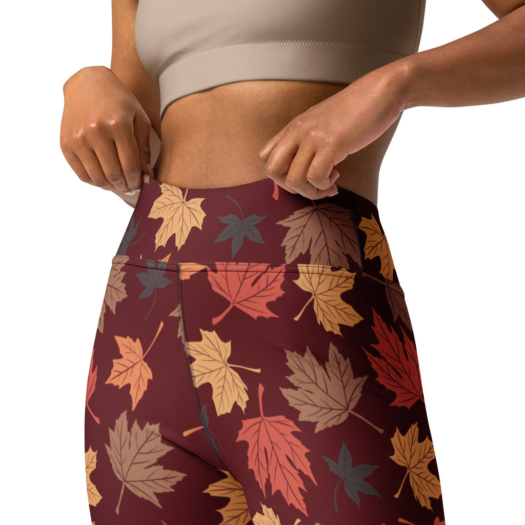 Maroon high-waisted buttery soft yoga leggings with vibrant autumn maple leaf pattern in orange red and brown shades