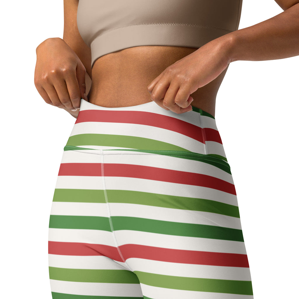 Women’s striped christmas buttery soft yoga leggings in red and green horizontal stripes paired with beige sports bra
