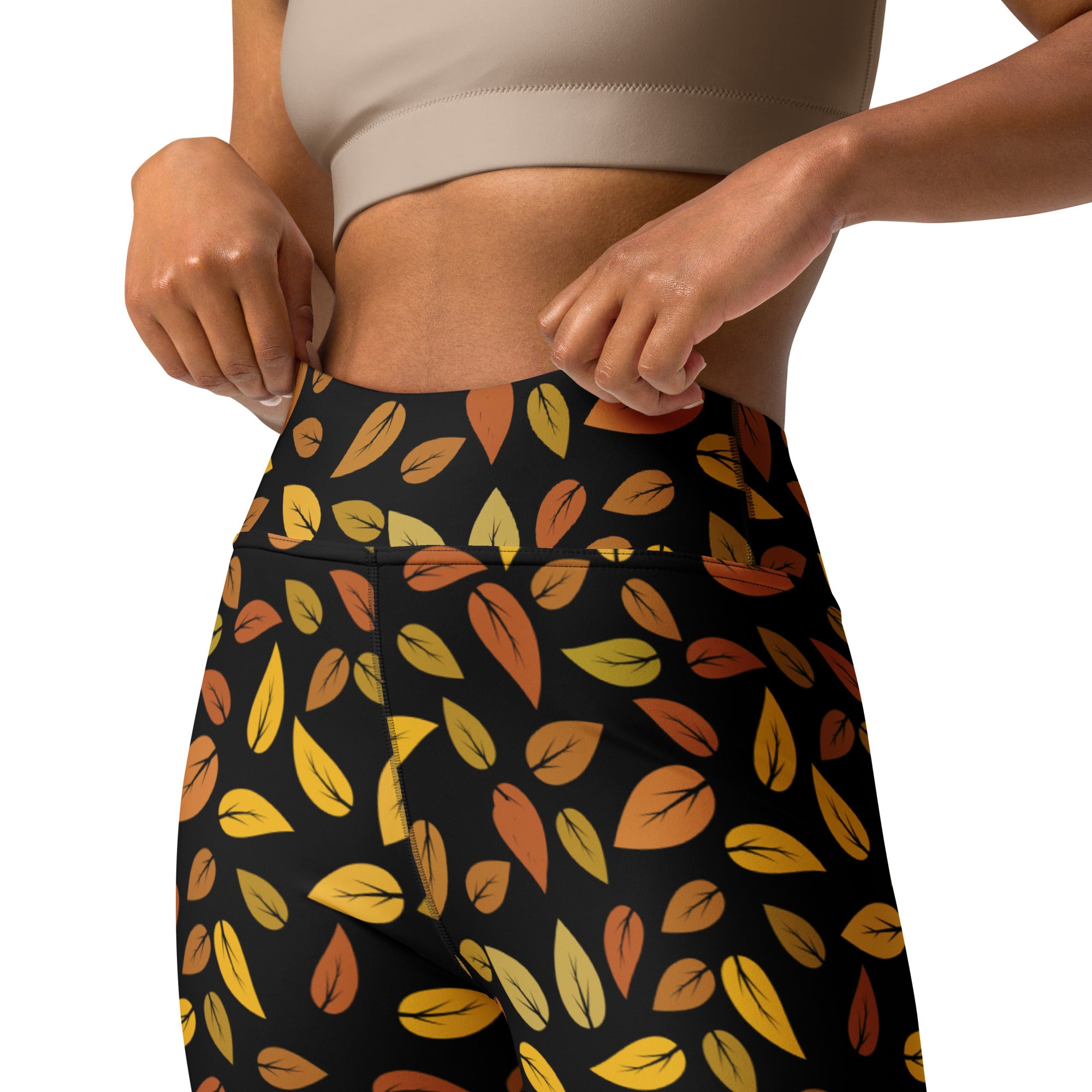 Black high-waisted buttery soft yoga leggings with vibrant gold autumn leaves pattern in yellow orange and brown