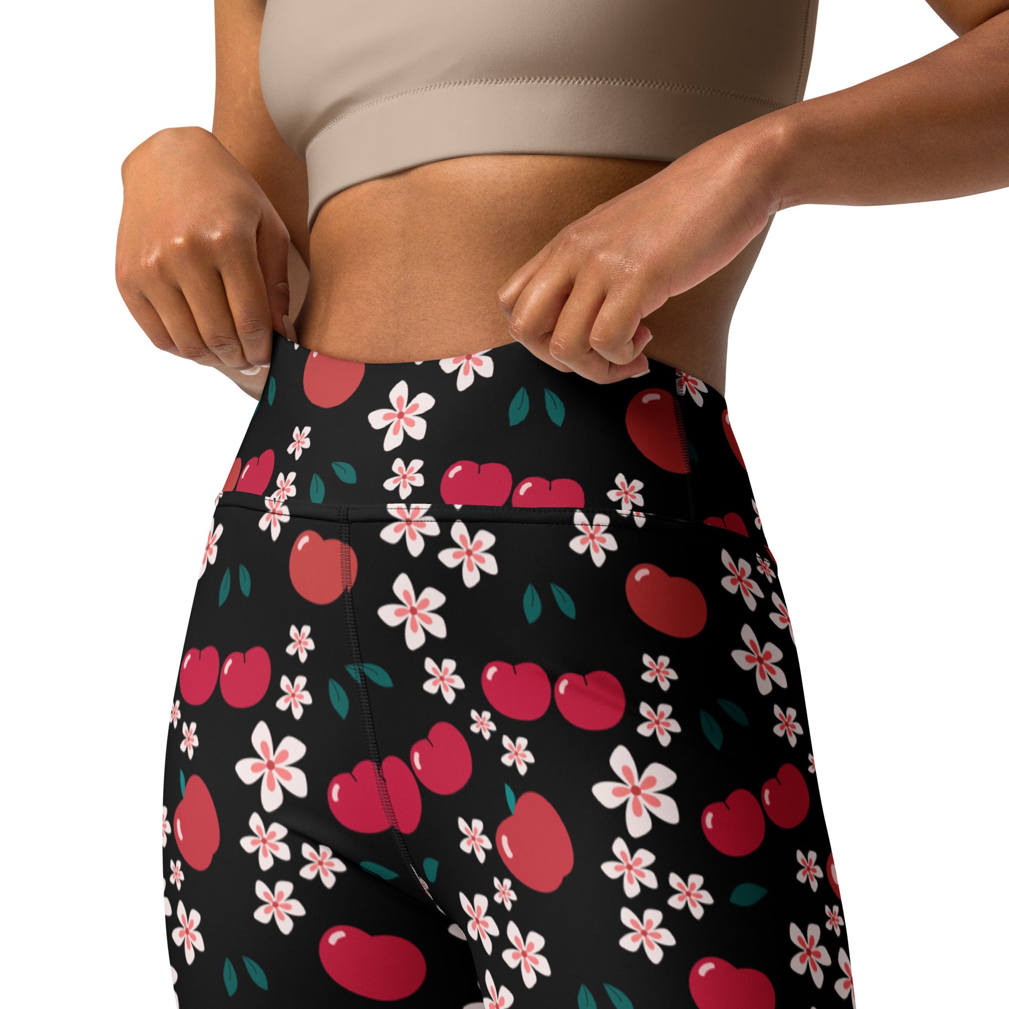 Women’s black high-waisted buttery soft yoga leggings with a vibrant red cherry apple blossom pattern