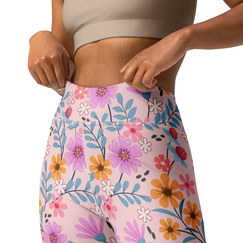 Women’s pink floral buttery soft high-waisted yoga leggings with vibrant purple orange white flowers and blue leaves