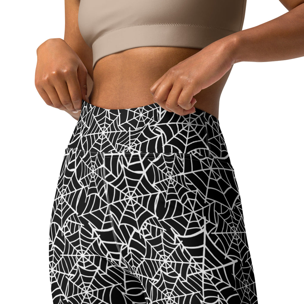 Black high-waisted buttery soft yoga leggings with intricate white spiderweb pattern for women halloween wear