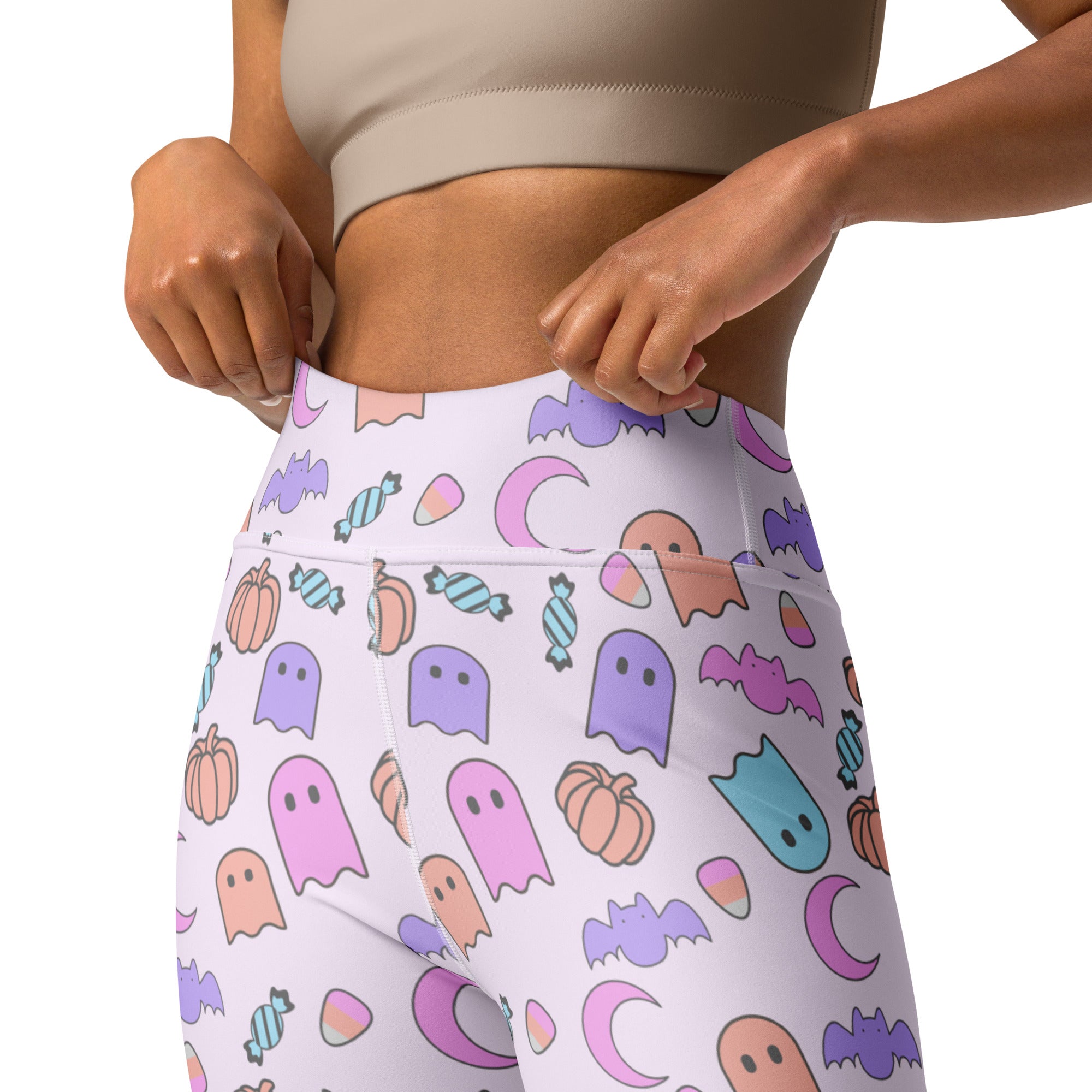 White high-waisted buttery soft yoga leggings for women with a pastel ghost halloween pattern of bats pumpkins and candy