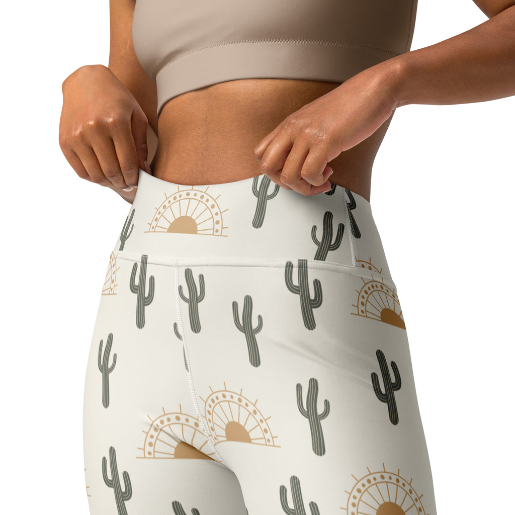 White high-waisted buttery soft yoga leggings with gray cactus and gold sunburst pattern for women