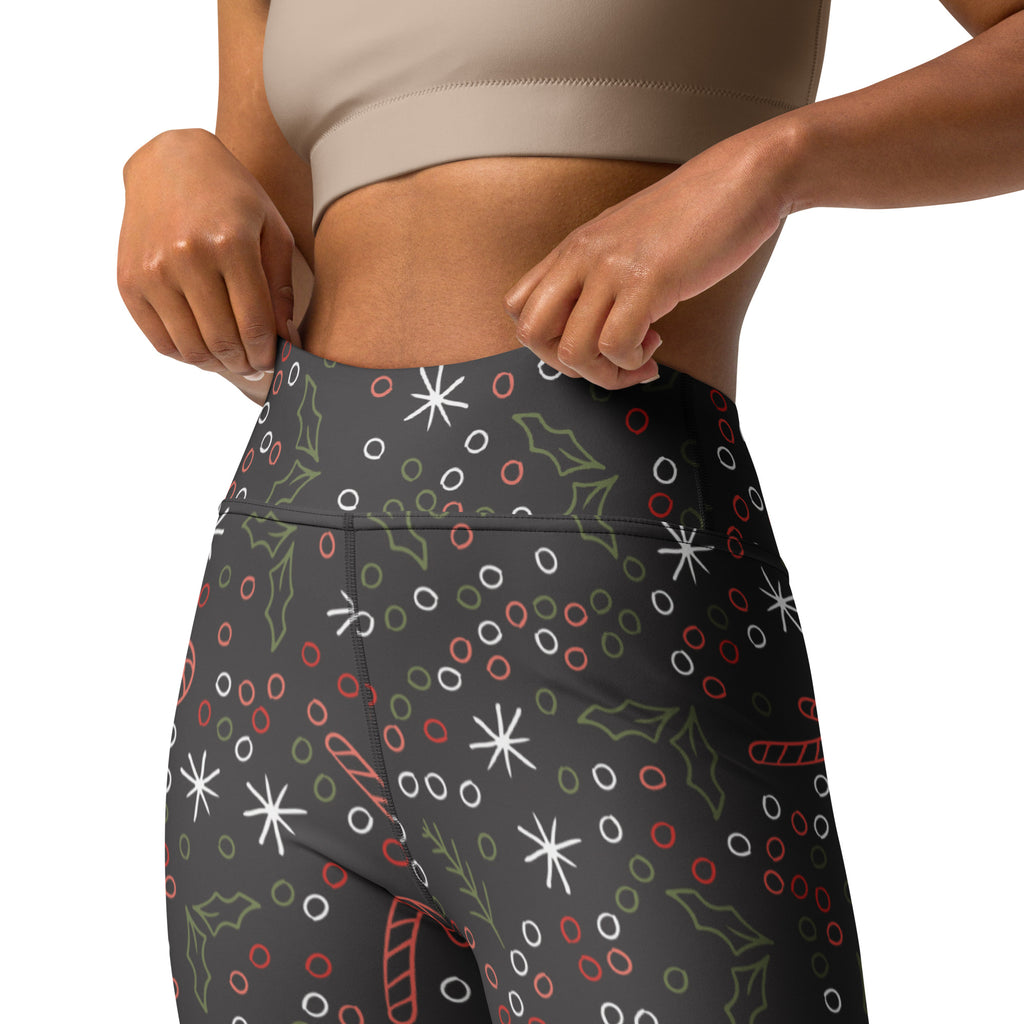 Women’s dark gray buttery soft yoga leggings with festive white stars red and green holly and candy cane patterns