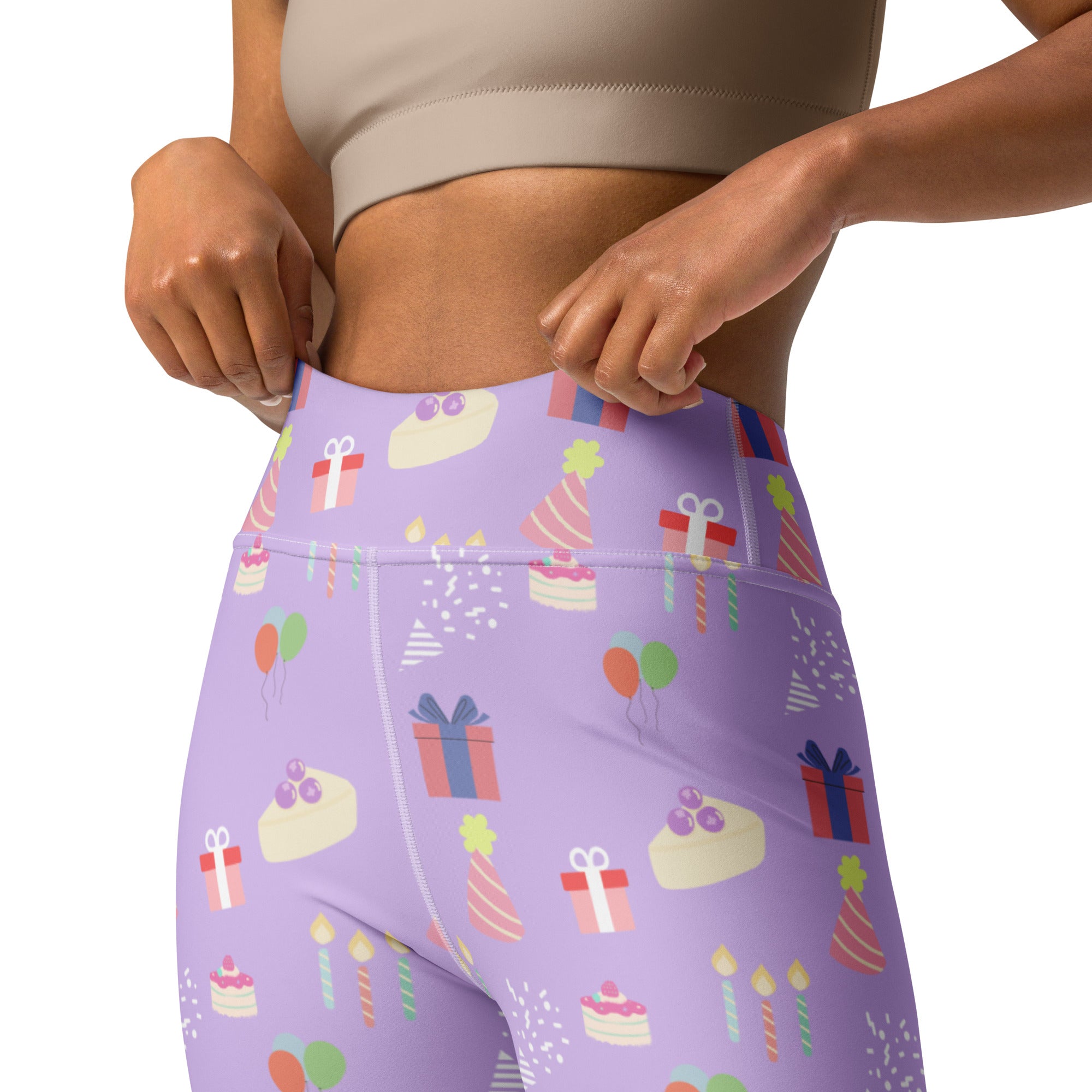 Women’s purple high-waisted buttery soft yoga leggings with playful birthday cake gifts and party hat pattern