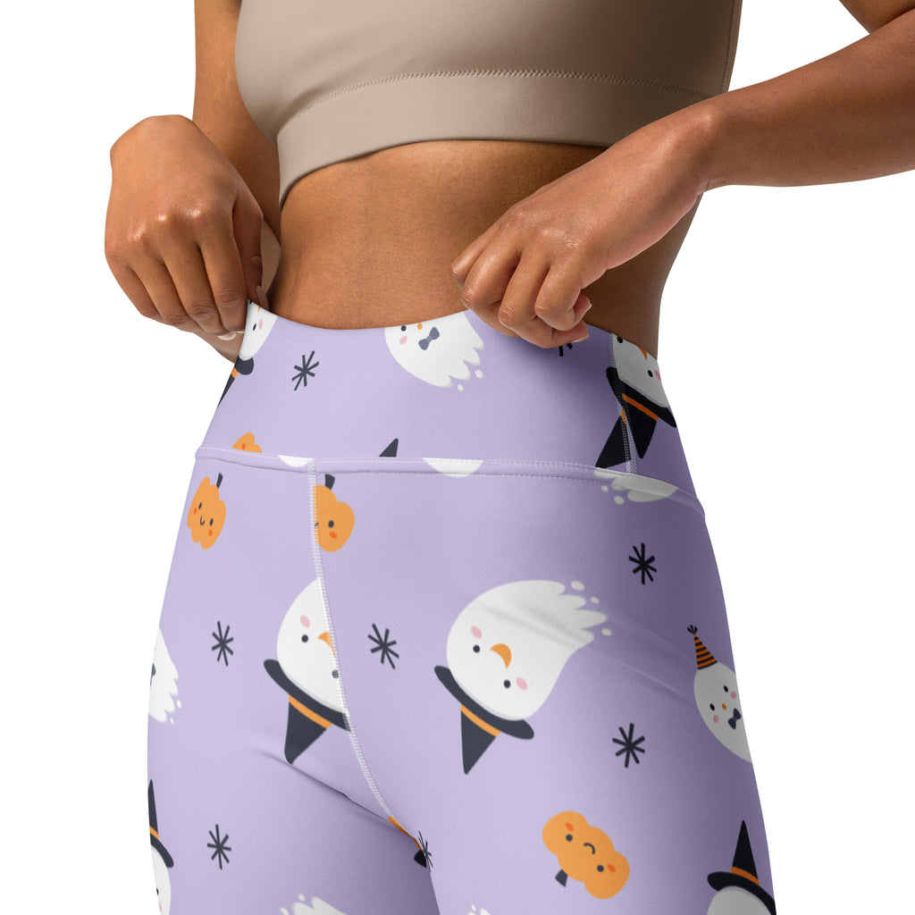 Purple high-waisted buttery soft yoga leggings with playful halloween ghosts in witch hats and smiling pumpkins pattern