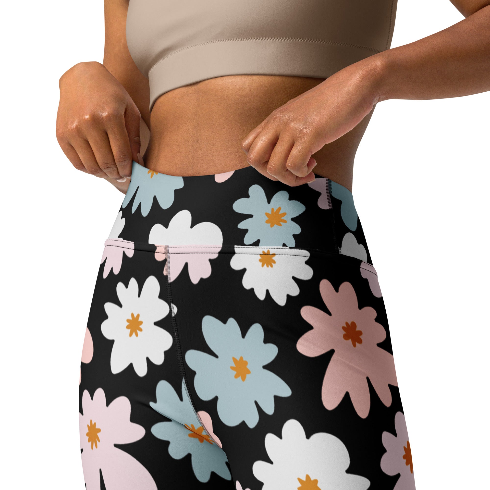 Black high-waisted buttery soft yoga leggings with vibrant white light blue and pink daisy floral pattern and orange centers