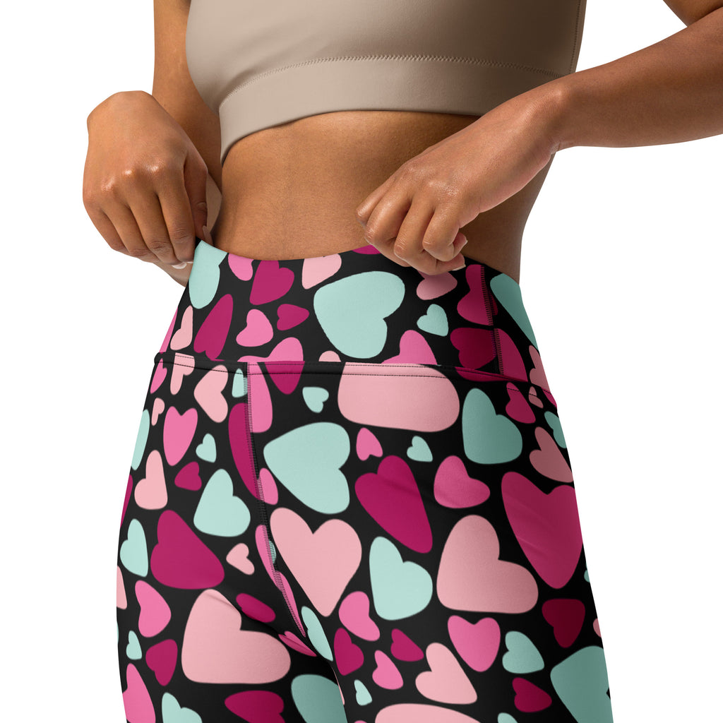 High waisted women’s yoga leggings with vibrant pink magenta and mint green hearts on black buttery soft quick drying fabric