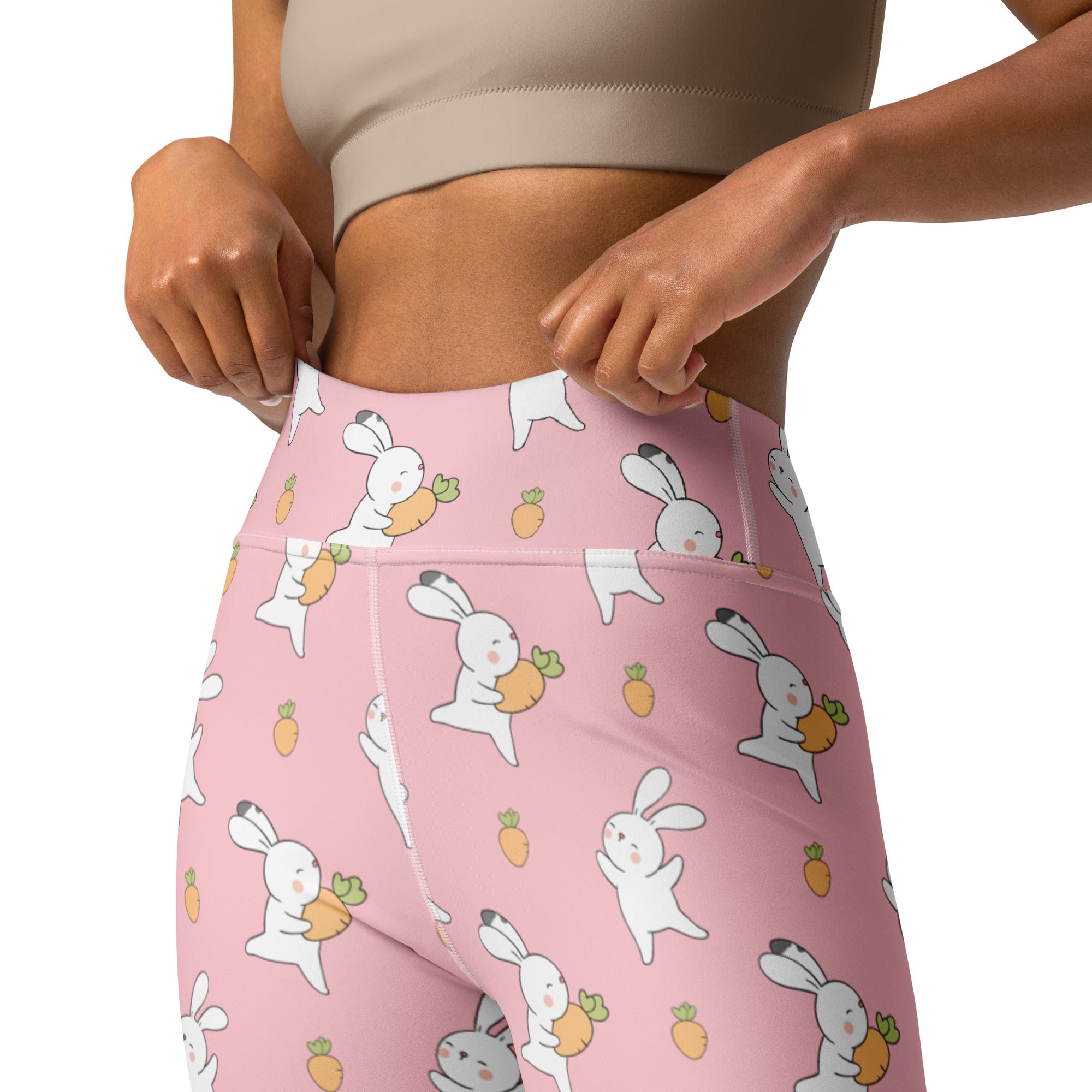 Women’s pink high waisted buttery soft yoga leggings with white cartoon bunnies and orange carrot pattern