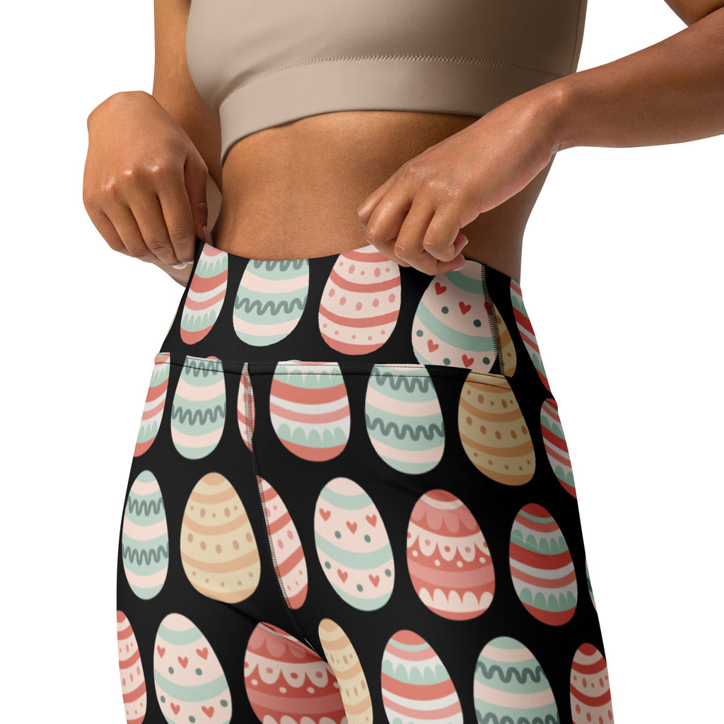 Black high waisted buttery soft yoga leggings with colorful pastel easter eggs in pink mint and beige decorative pattern
