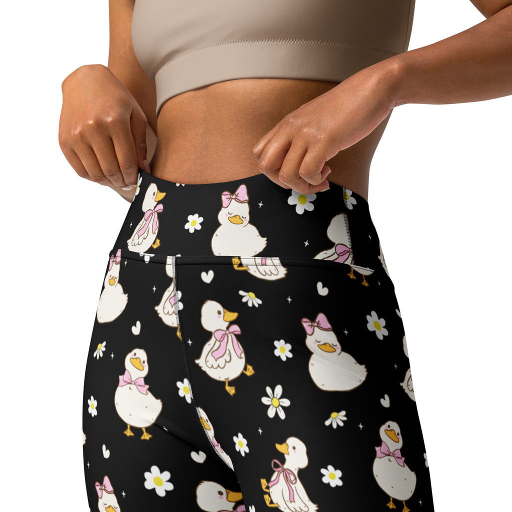 Black high-waisted buttery soft yoga leggings with white cartoon ducks pink bows daisies and hearts quick drying