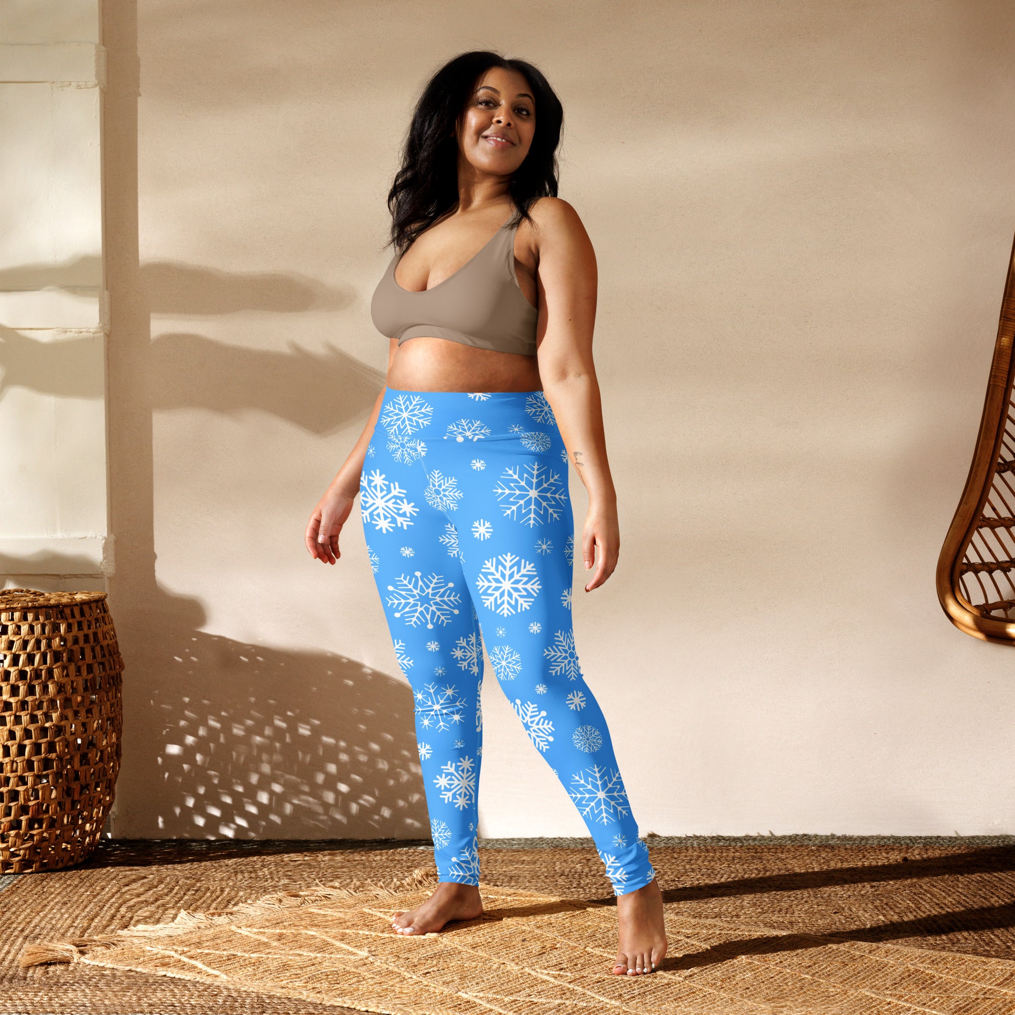 Women’s blue buttery soft yoga leggings with white snowflake patterns ideal for winter workouts