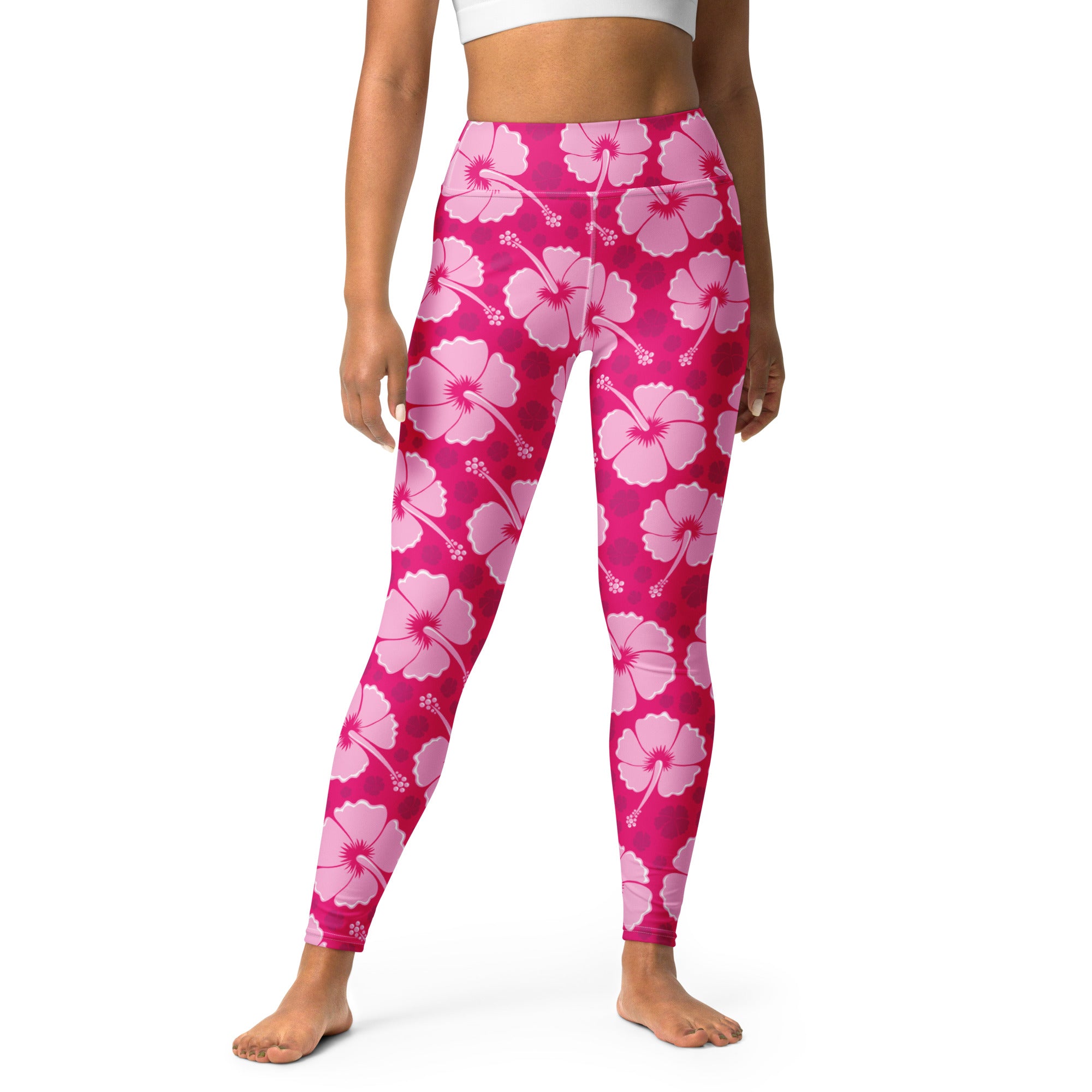 Women’s high-waisted pink hibiscus floral leggings made of buttery soft fabric perfect for yoga and tropical wear