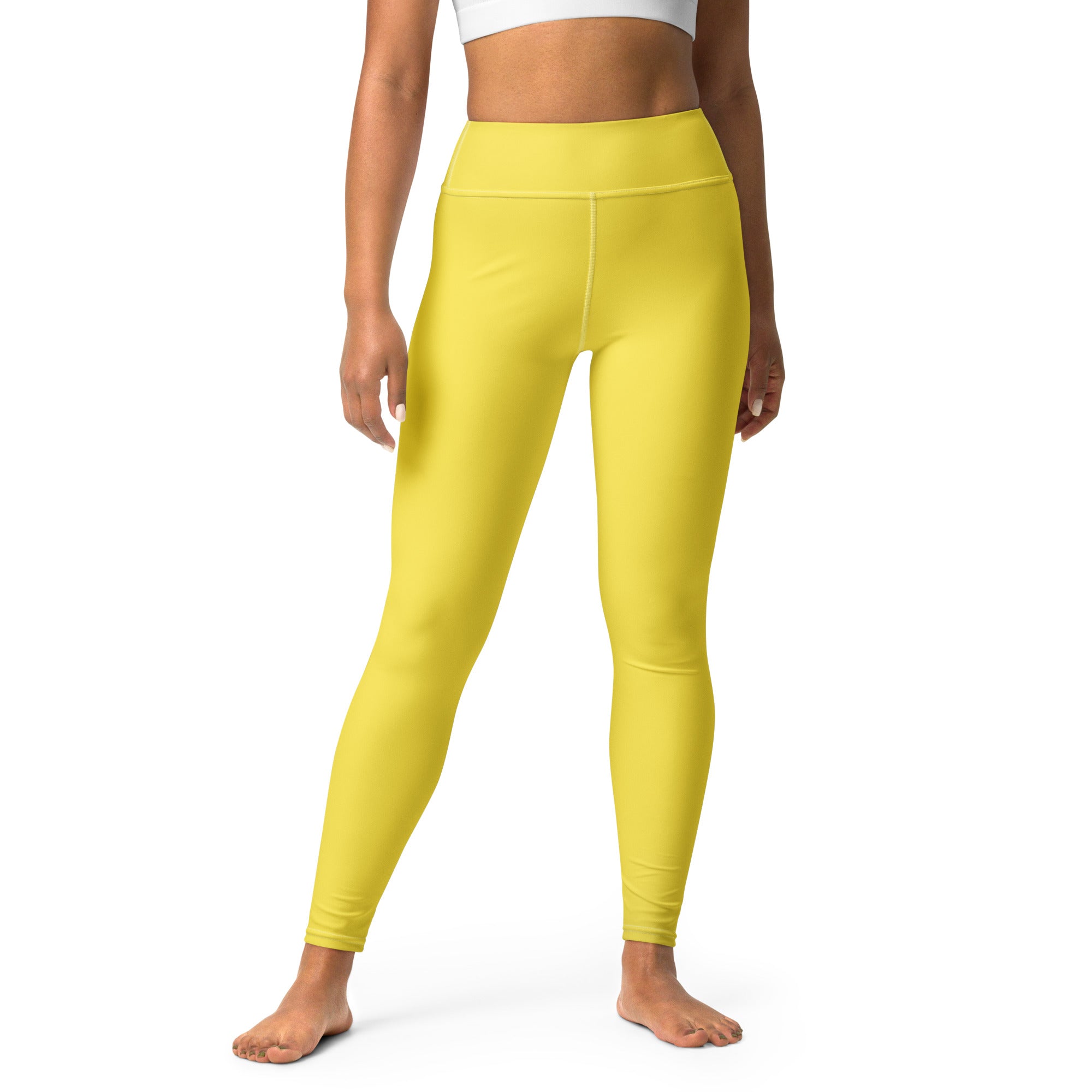 Bright yellow high-waisted buttery soft yoga leggings made of stretchy form-fitting fabric for women