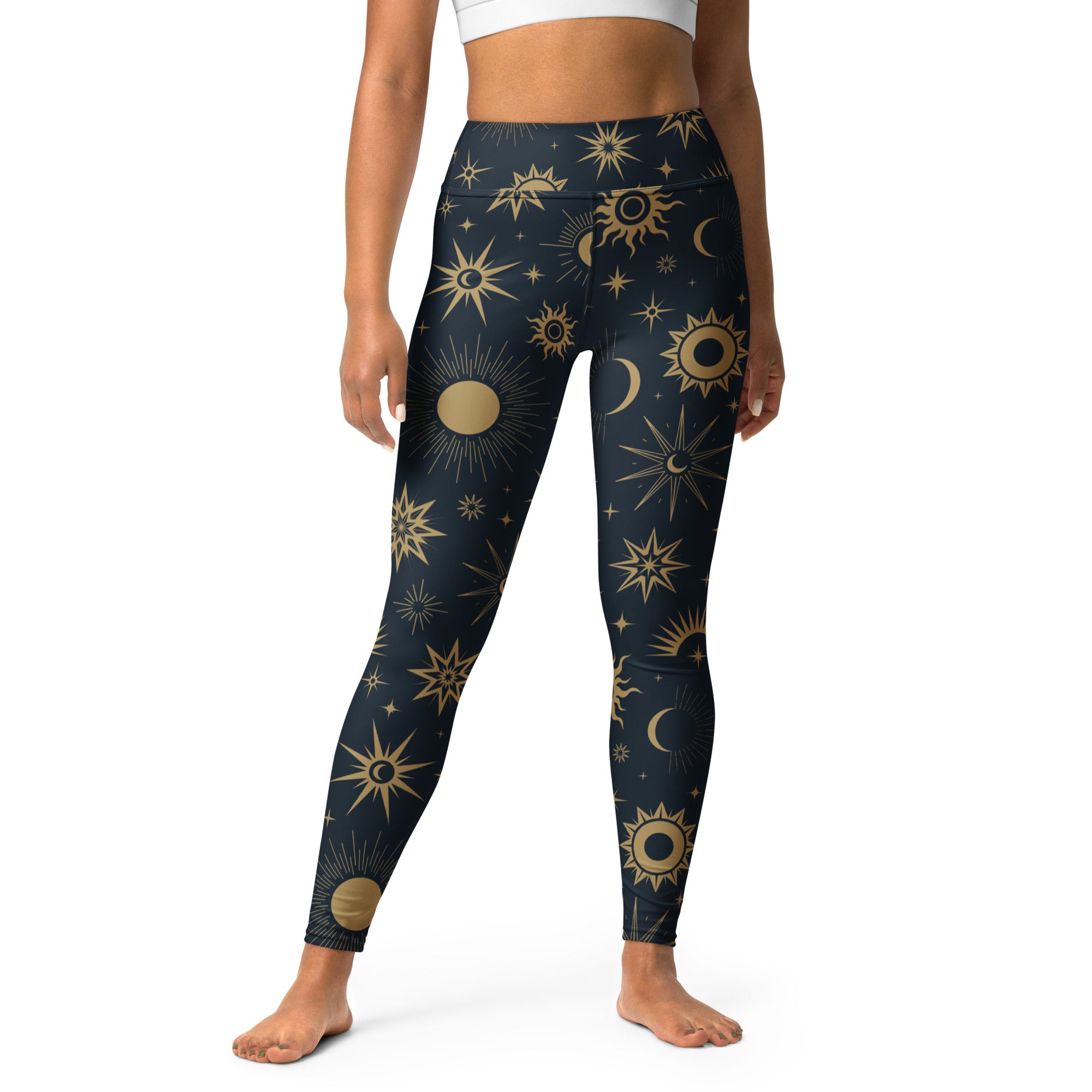 Dark blue high-waisted buttery soft yoga leggings with vibrant gold celestial sun moon and star pattern