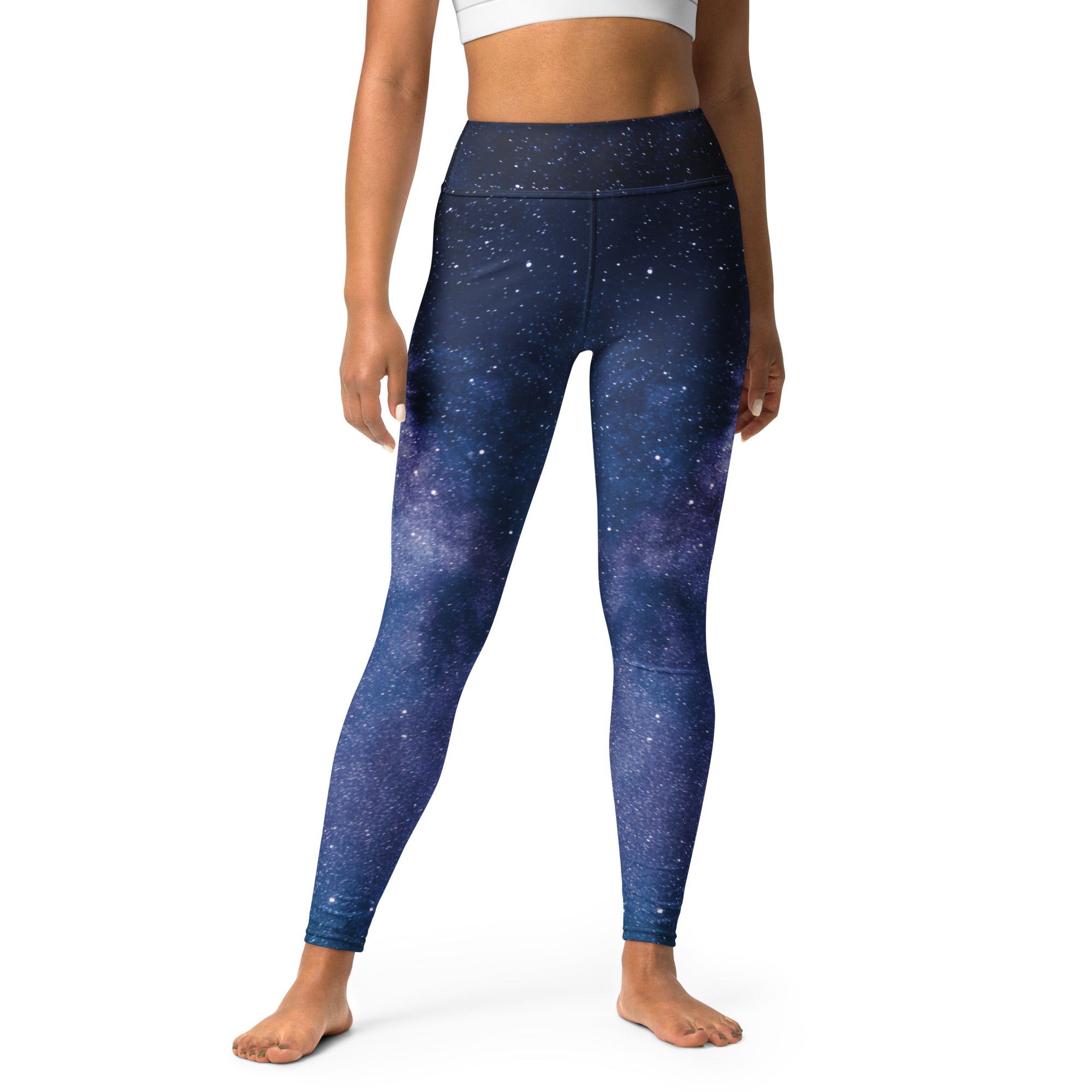 Dark blue high-waisted galaxy leggings with starry print and buttery soft fabric for women’s yoga and activewear