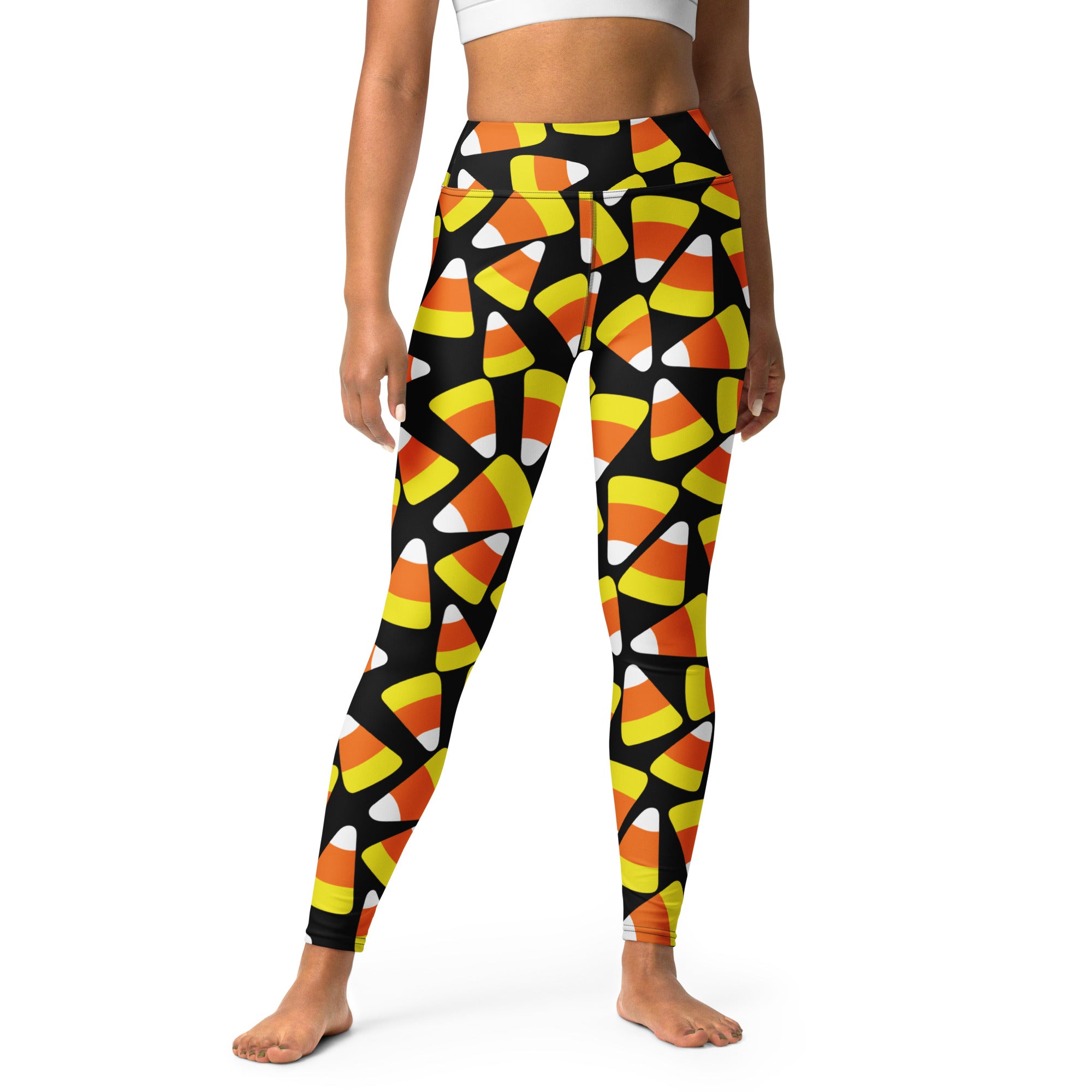 Black buttery soft women’s yoga leggings with vibrant orange yellow and white candy corn pattern for halloween