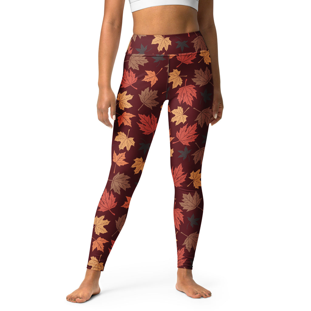 Women’s maroon buttery soft yoga leggings with vibrant autumn maple leaf pattern in orange red and brown shades