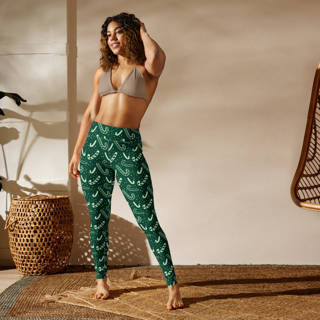 Women’s green buttery soft yoga leggings with white candy cane patterns perfect for Christmas workouts